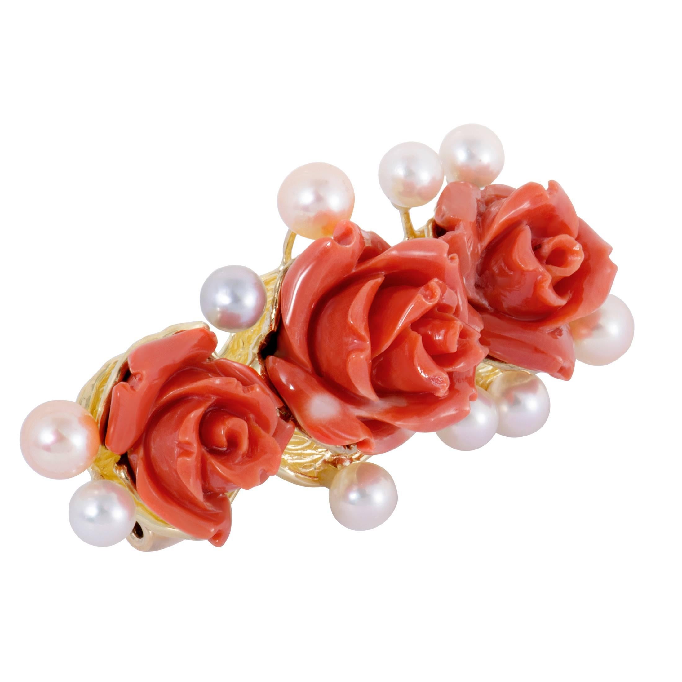 With gorgeously dainty coral flowers taking the central spot - surrounded by sublime pearls - this lovely brooch exudes grace and femininity. The brooch is made of radiant 18K yellow gold and weighs 21 grams.
