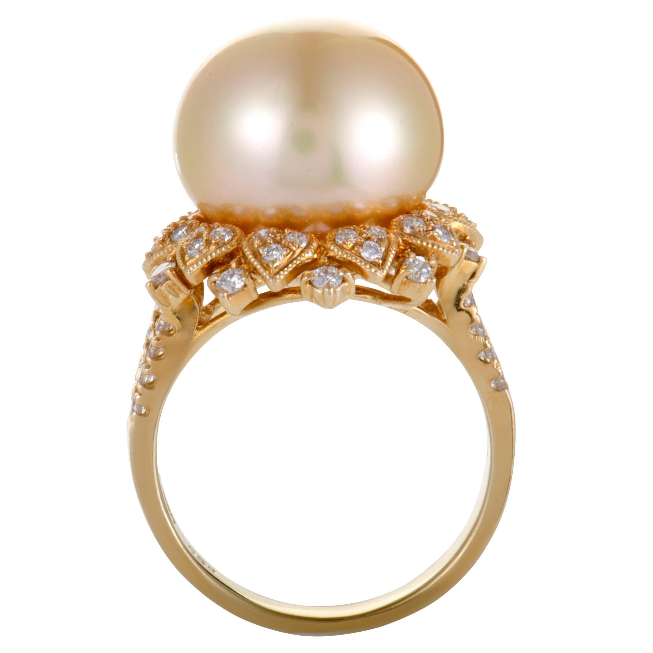 A charmingly antique feel is given to this lovely ring by the intricate design and classic décor. The ring is made of elegant 18K yellow gold and boasts a sublime pearl, its feminine allure enhanced by scintillating diamonds that total 0.58