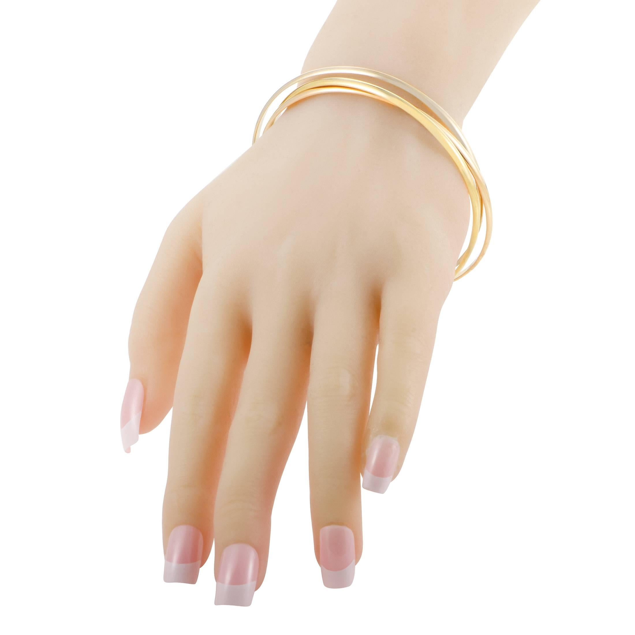 Capturing the essence of the brands iconic Trinity design, this fantastic bracelet from Cartier is made of radiant 18K yellow gold, delightful 18K rose gold and splendid 18K white gold, all crafted into elegantly minimalist and spotlessly gleaming