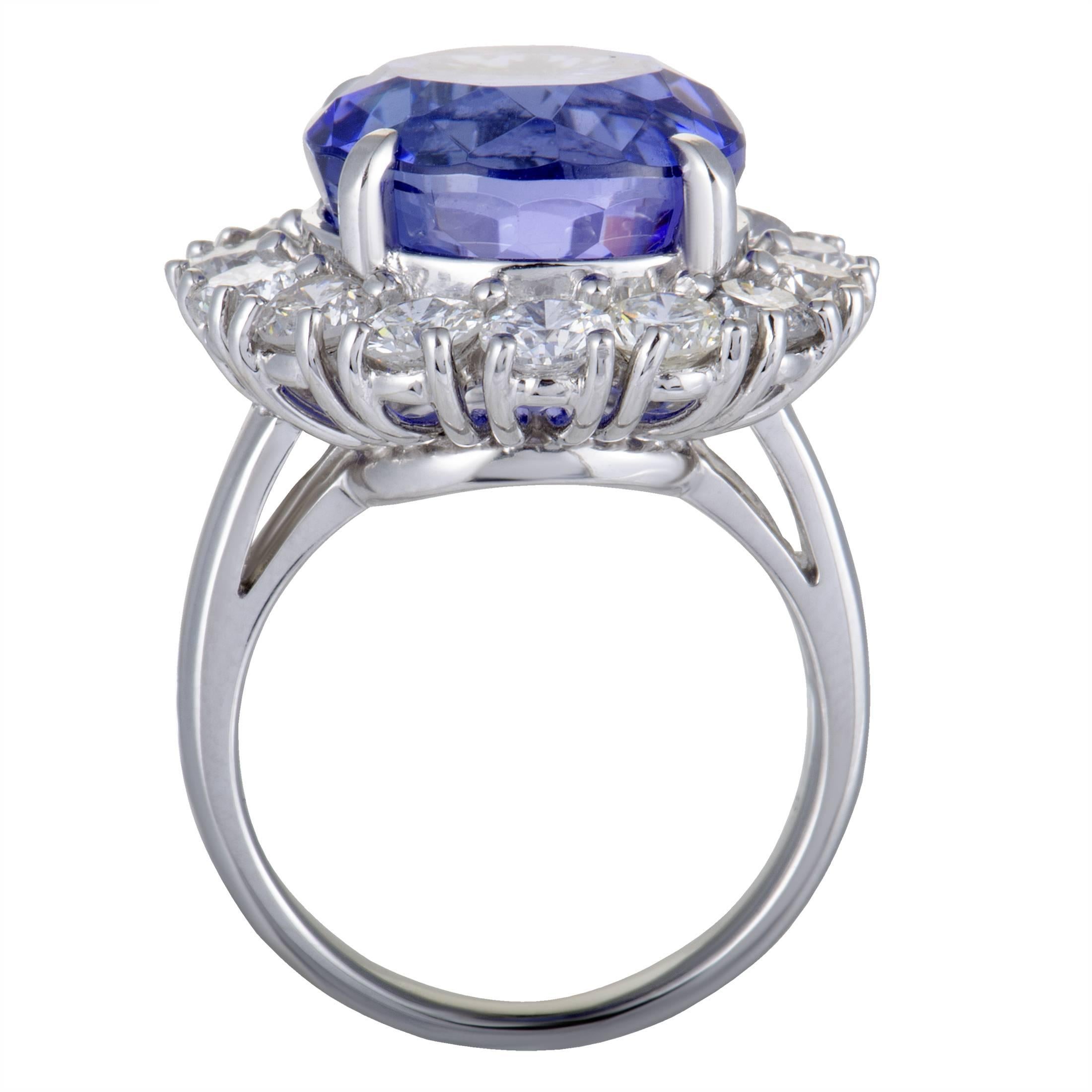 This stunning ring is made of prestigious platinum and set with the ever-compelling blend of resplendent diamonds and striking tanzanite, boasting an exceptionally refined appeal. The tanzanite weighs 12.50 carats and the diamonds total 3.12