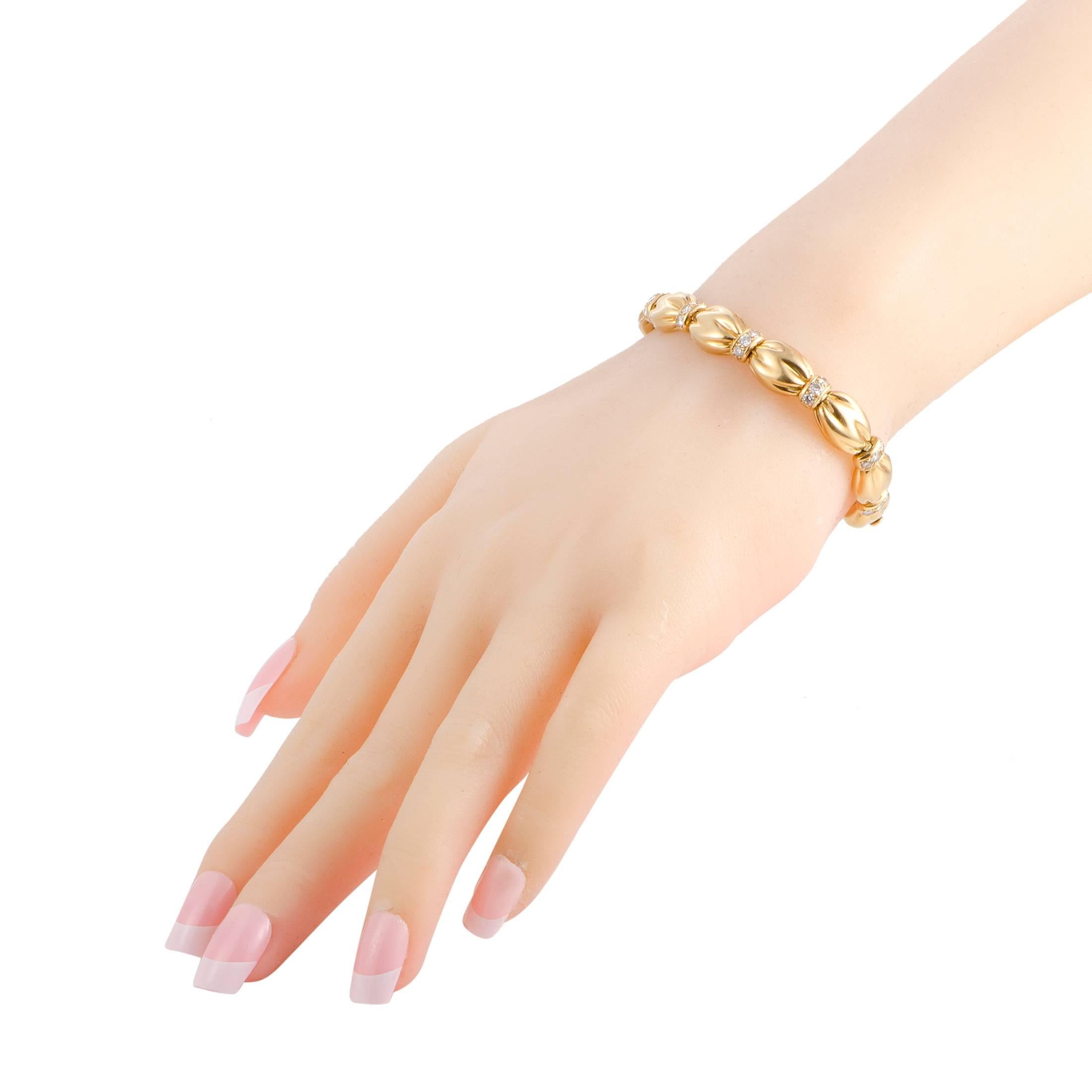 Brilliantly designed, expertly executed and tastefully embellished with sparkling F-color diamonds of VS clarity amounting to 1.67 carats, the fabulous 18K yellow gold sets a gorgeously feminine and luxurious tone in this stunning vintage bracelet