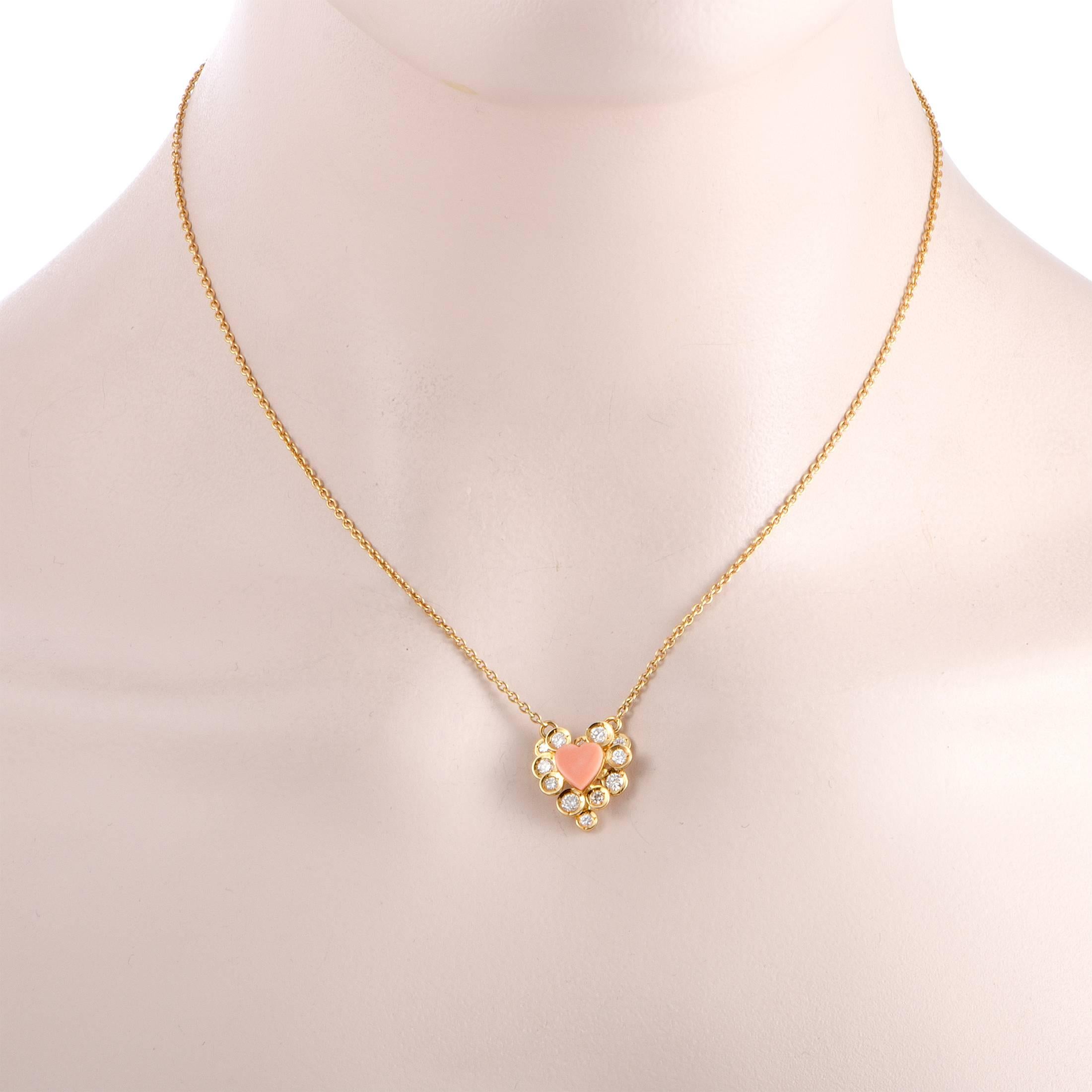 Designed by Van Cleef & Arpels, this lovely 18K yellow gold necklace is presented with a nifty chain onto which a dainty heart pendant is attached. The pendant is decorated with a sublime coral and approximately 0.50 carats of glistening diamonds of