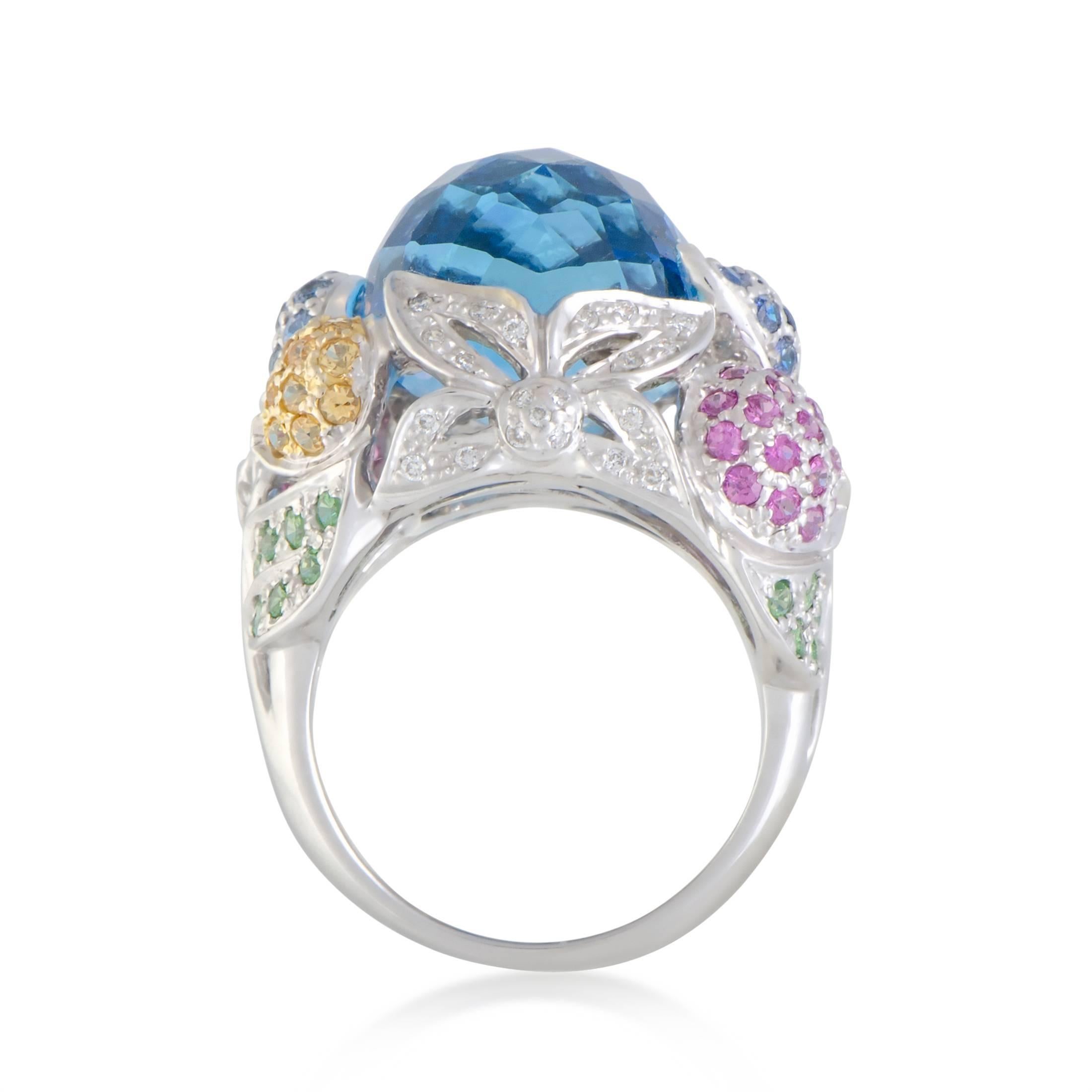 Producing a truly extraordinary sight and a simply unforgettable visual effect by brilliantly combining diverse gems, this astonishing 18K white gold ring boasts scintillating diamonds amounting to 0.20ct and vivacious multicolored sapphires beneath