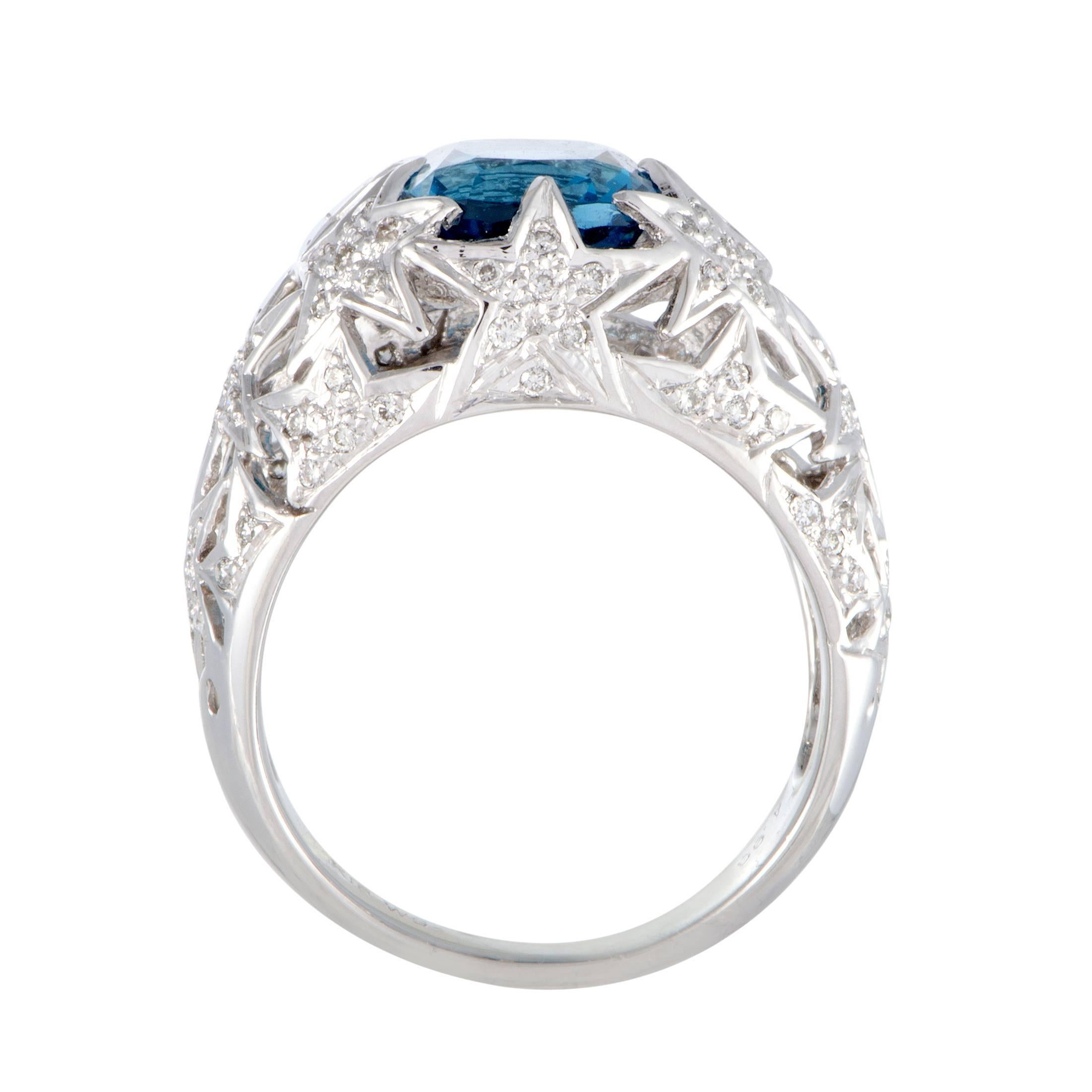 The stars in this extraordinary 18K white gold ring glisten in an exceptionally luxurious manner thanks to the plethora of scintillating diamonds that embellish them. The ring is given a touch of color by a sublime topaz that weighs 4.93 carats,