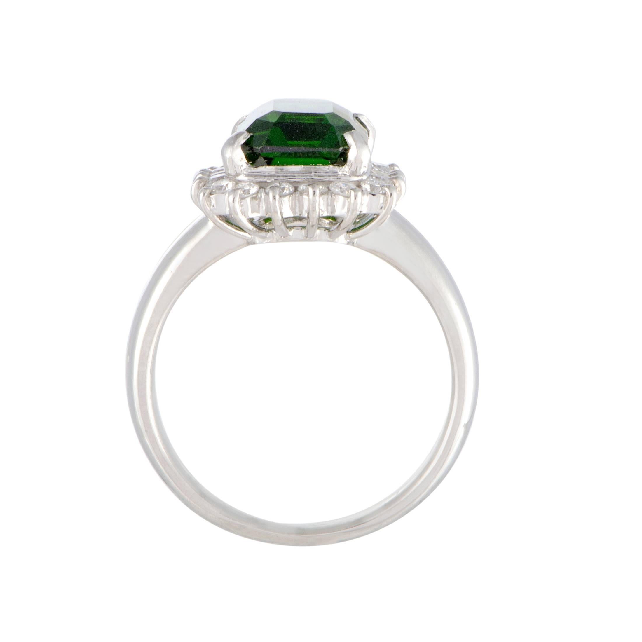 Designed in a splendidly classic style and luxuriously decorated, this ring boasts a compellingly refined appeal. Made of platinum, the ring features an eye-catching green tourmaline that weighs 2.75 carats, surrounded by scintillating diamonds that
