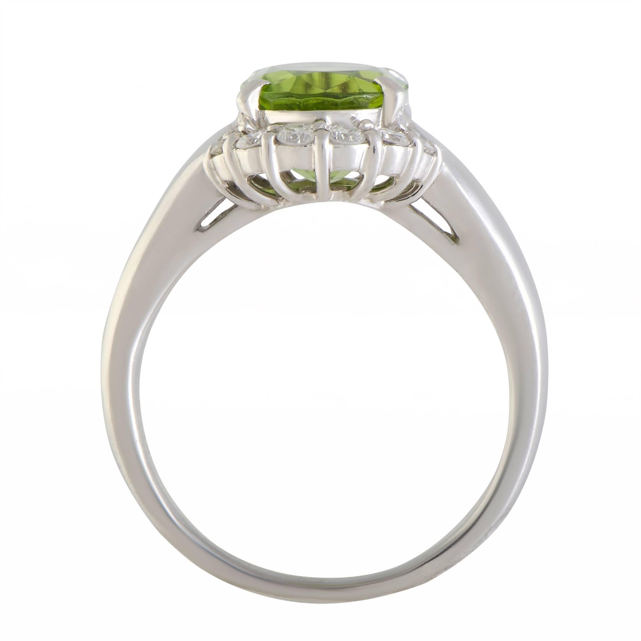 The splendid peridot is accompanied by glistening diamonds and gives an exceptionally prestigious appeal to this classy ring. The ring is made of platinum and weighs 12.5 grams, and the diamond stones total 0.41 carats.
Ring Size 9
Band 4mm 
Top
