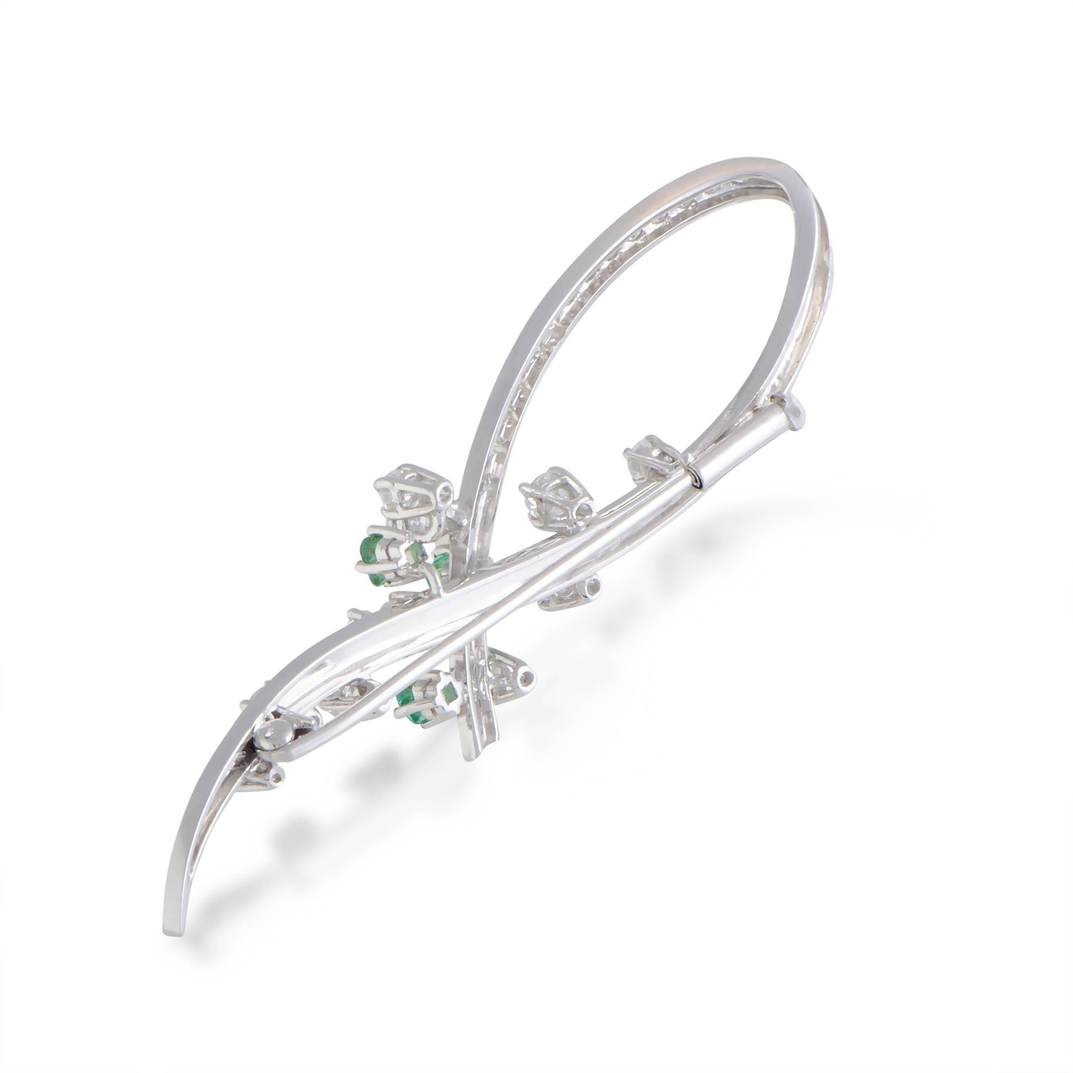 This beautiful 18K white gold brooch perfectly epitomizes elegance and class. The spectacular design includes a stunning blend of 1.10ct of diamonds and mesmerizing 0.50ct of emeralds that give the brooch an extravagantly stylish appeal.
