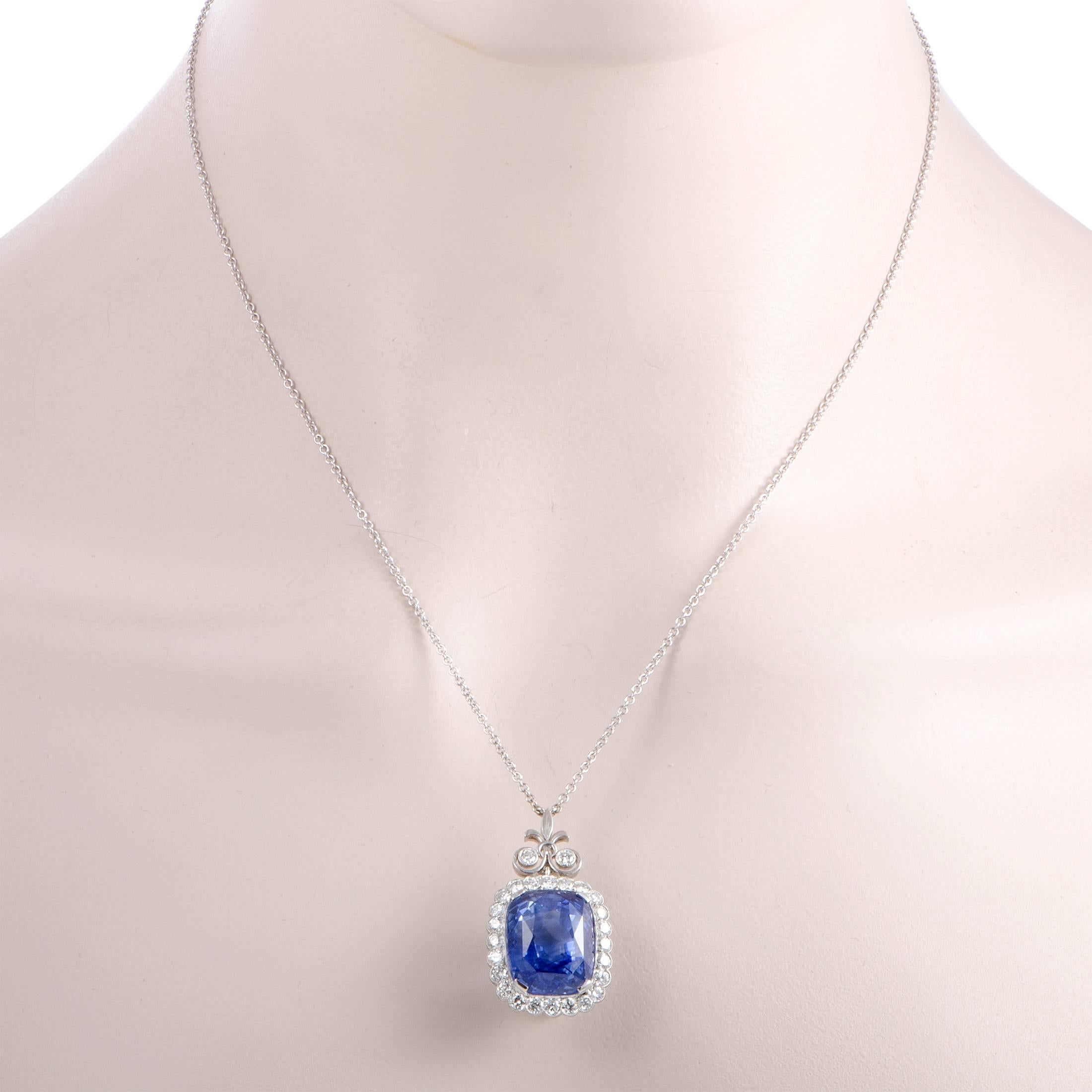 Featuring an intricately ornamented pendant set with a captivating sapphire and a plethora of resplendent diamond stones, this splendid necklace boasts an incredibly regal appeal. Made of elegant 18K white gold, the necklace is decorated with a