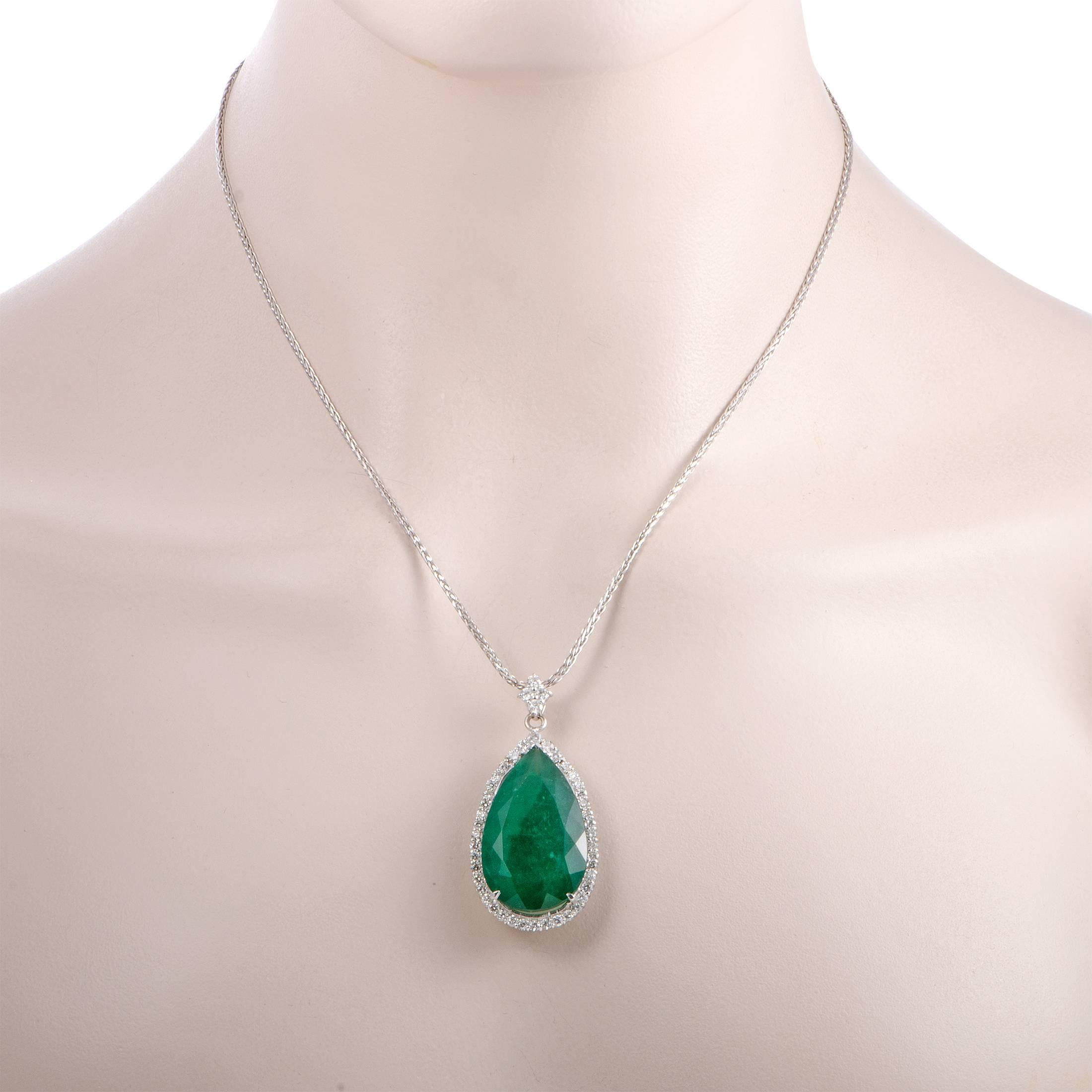 The exquisitely cut emerald steals the show in this superb 18K white gold necklace that features a dainty chain onto which an eye-catching pendant is attached. The emerald weighs 33.30 carats and it is accompanied by 2.10 carats of scintillating