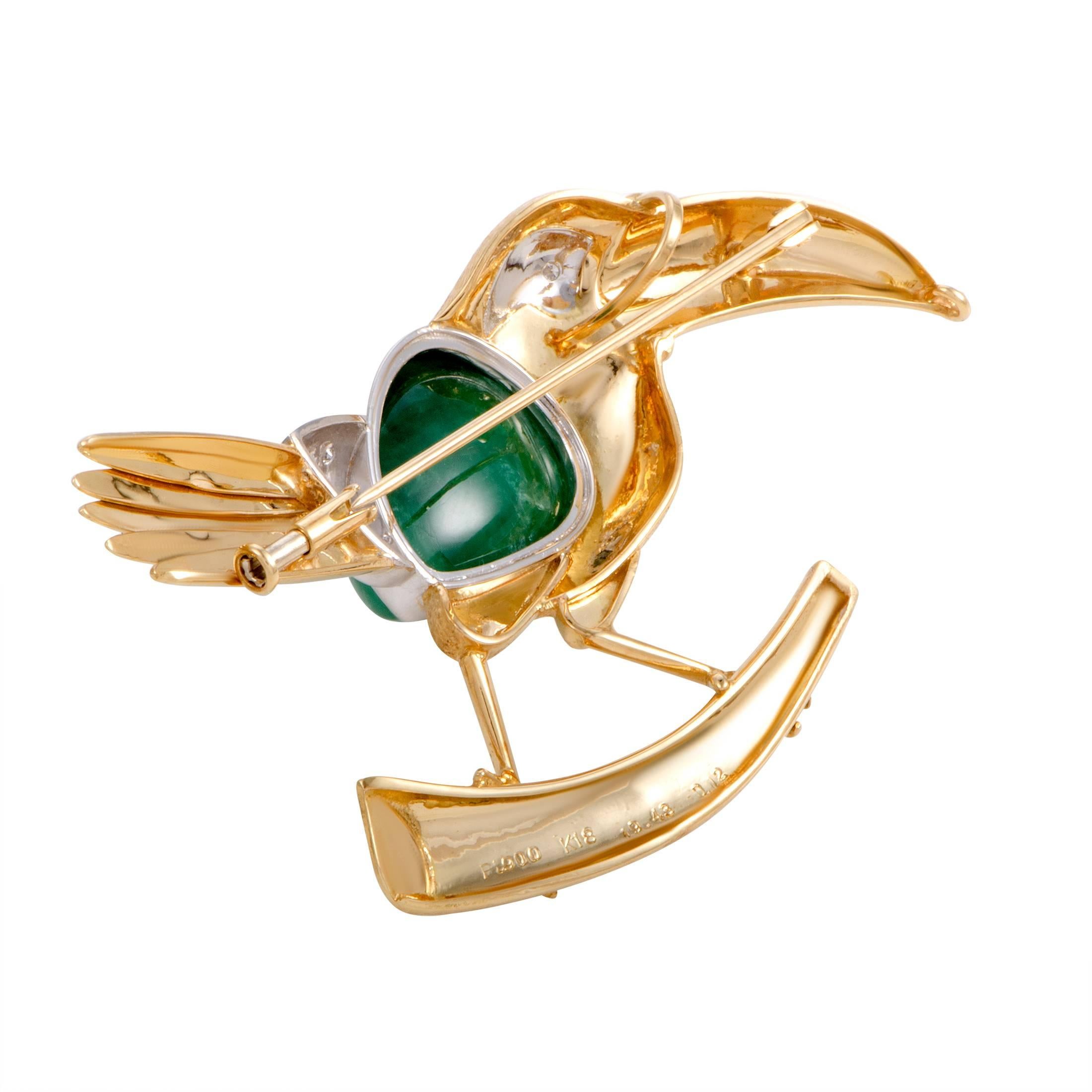 Depicting a bird in an exceptionally luxurious manner, this eye-catching brooch offers an incredibly offbeat, fashionable appearance. The brooch is made of 18K yellow gold and platinum decorated with 0.12 carats of diamonds and a captivating emerald