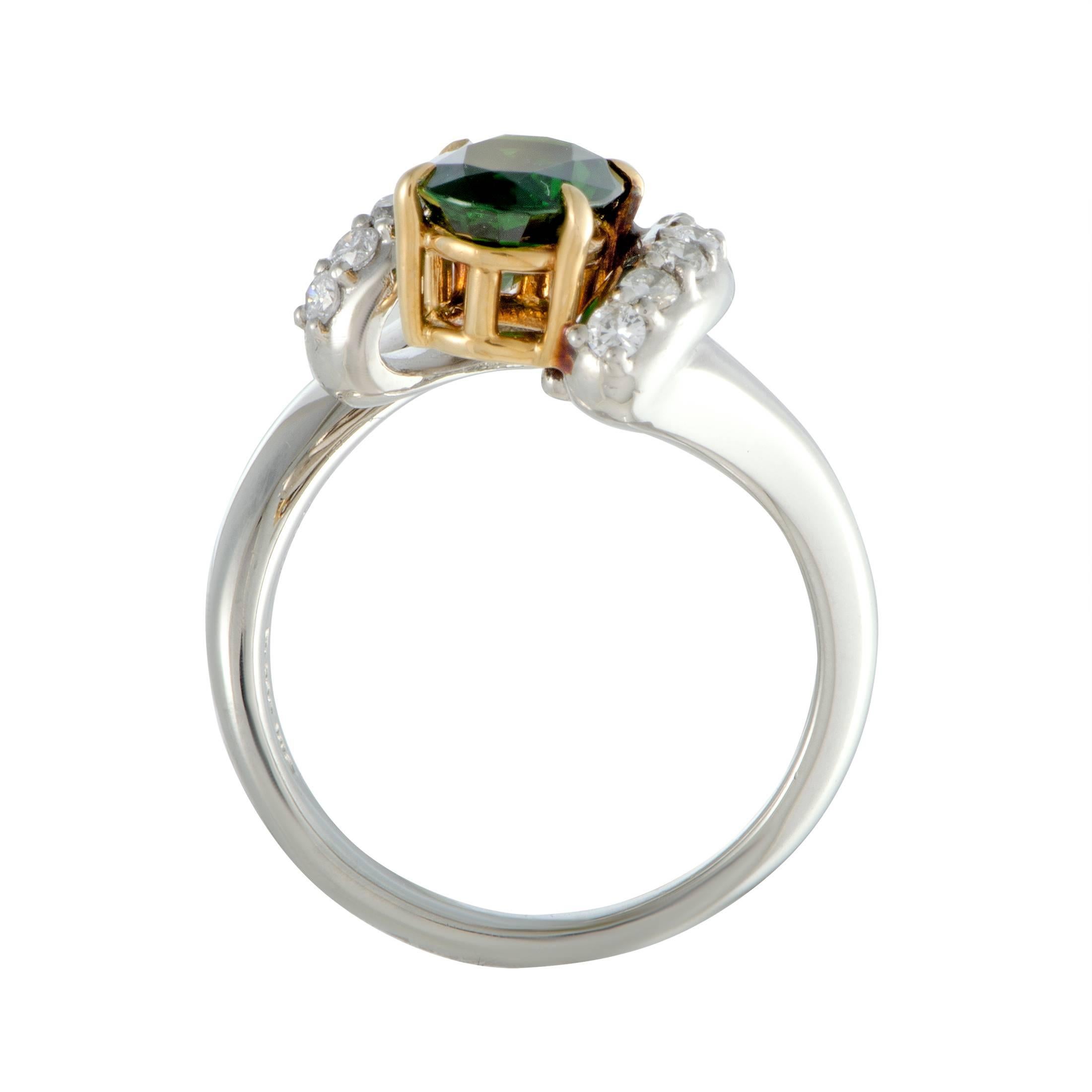 Offbeat design and bold combination of platinum and 18K yellow gold produce an incredibly eye-catching effect in this stunning ring that boasts an incredibly fashionable appeal. The ring features 0.45 carats of diamonds and a green tourmaline center