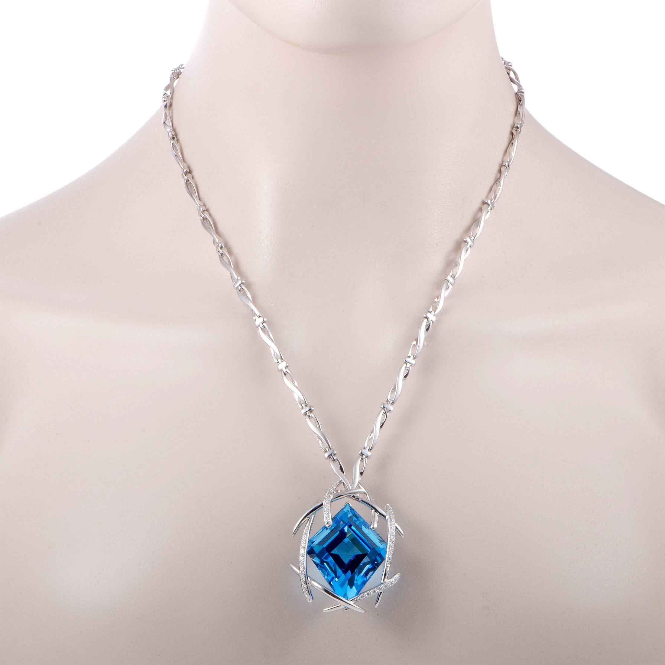 The majestic topaz steals the show in this fabulous necklace, compelling with its exquisite cut and enticing color. The topaz weighs astounding 90.80 carats and it is beautifully accentuated by glistening diamonds that amount to 0.70 carats. The