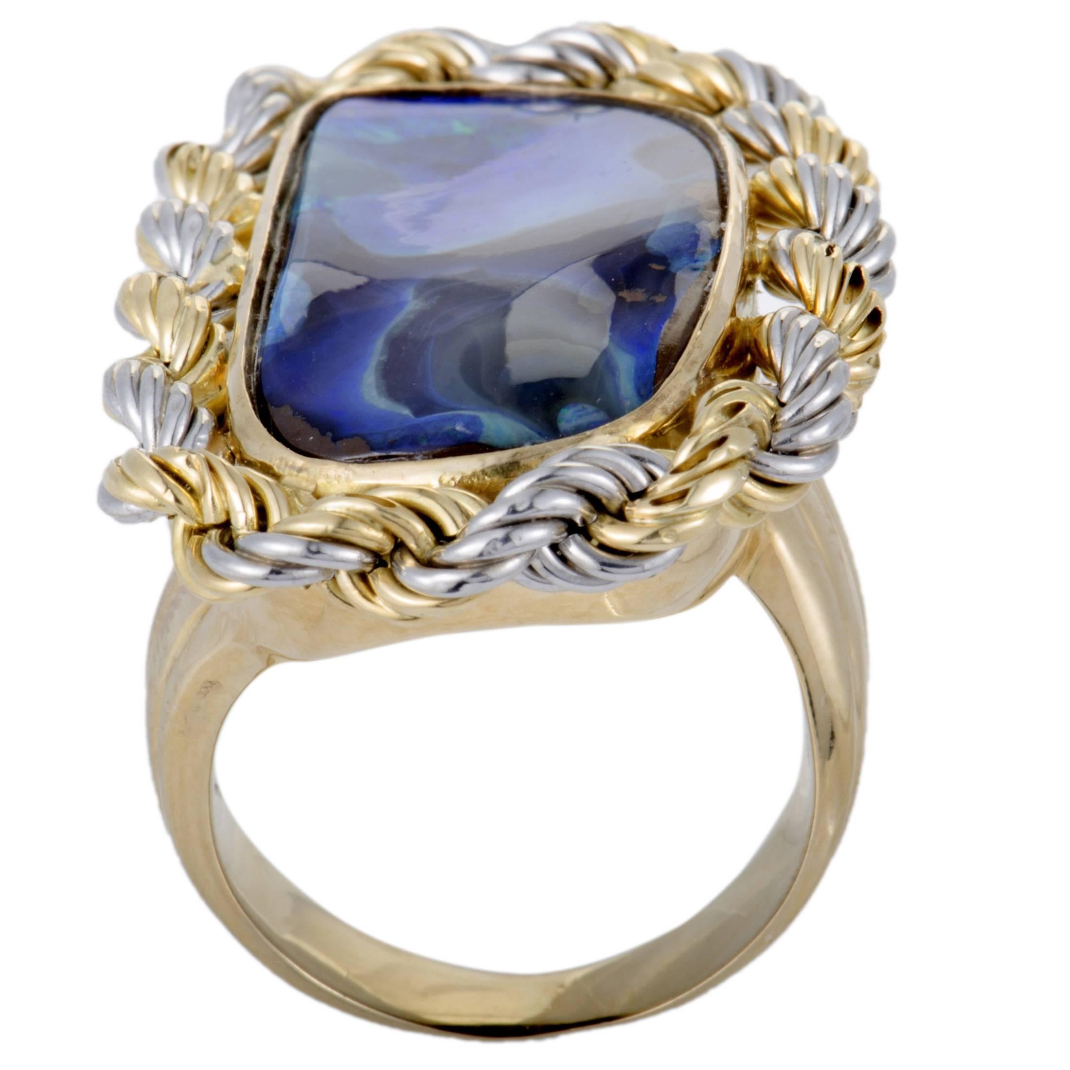 Featuring an incredibly unconventional combination of 18K yellow and white gold and opal, this fascinating ring offers a stunningly fashionable appearance. The opal weighs 18.99 carats.
Ring Top Dimensions: 38mm x 23mm
Band 7mm
Top 7mm
Ring Size 6.75