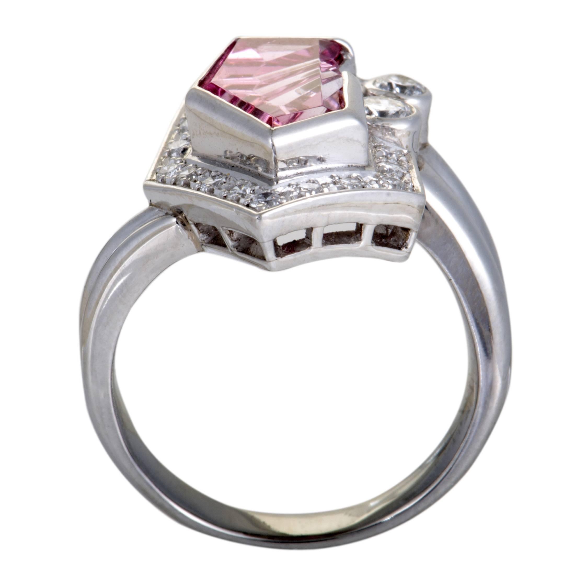 The offbeat design of this ring gives it a distinctly fashionable appeal, while the sumptuous décor comprised of diamond stones and a pink tourmaline adds a compelling touch of extravagance to the piece. The ring is made of platinum and boasts 0.39