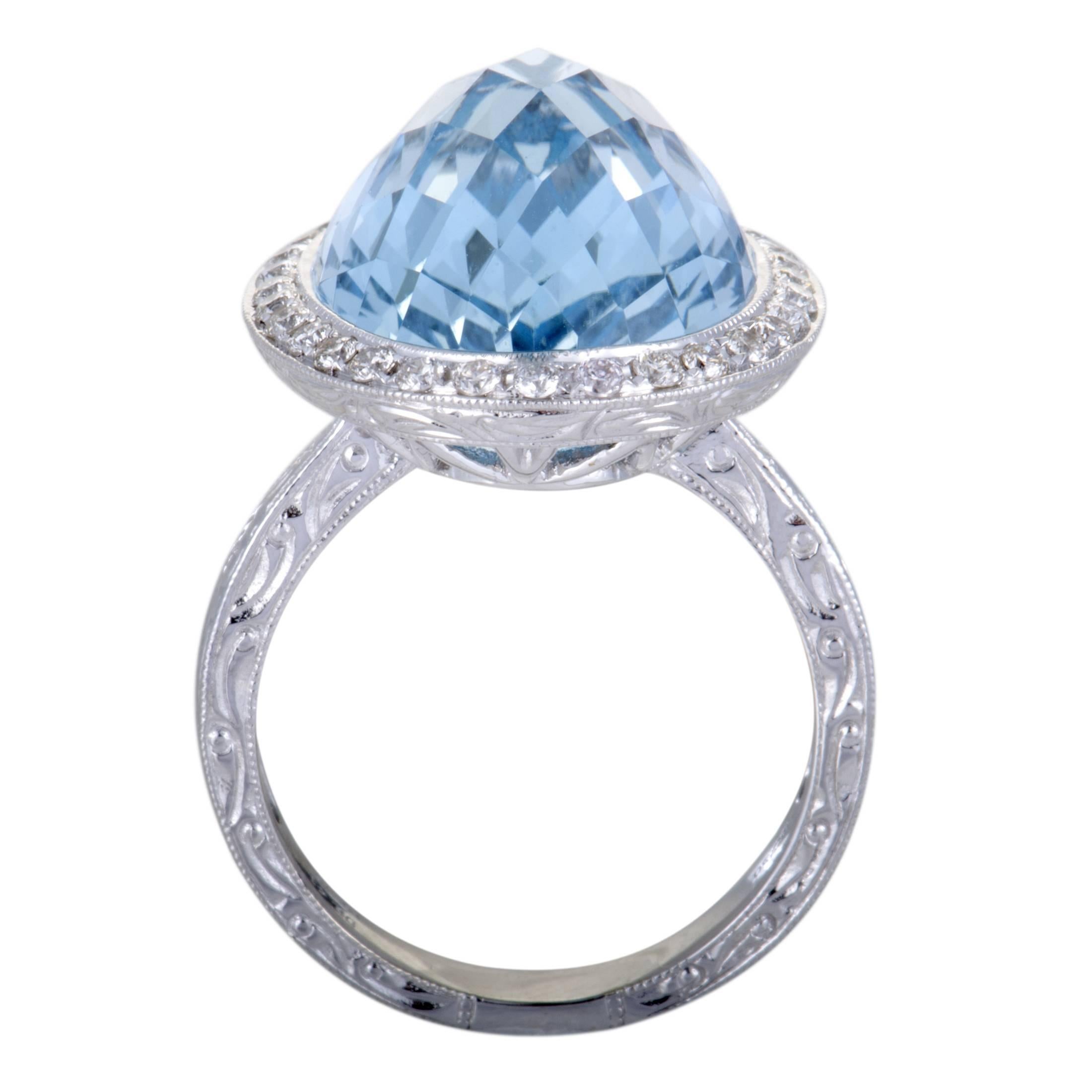 The alluring aquamarine nuance is gorgeously complemented by the bright gleam of 18K white gold and the scintillating resplendence of diamond stones in this fascinating cocktail ring. The aquamarine weighs 18.18 carats and the diamonds total 0.41