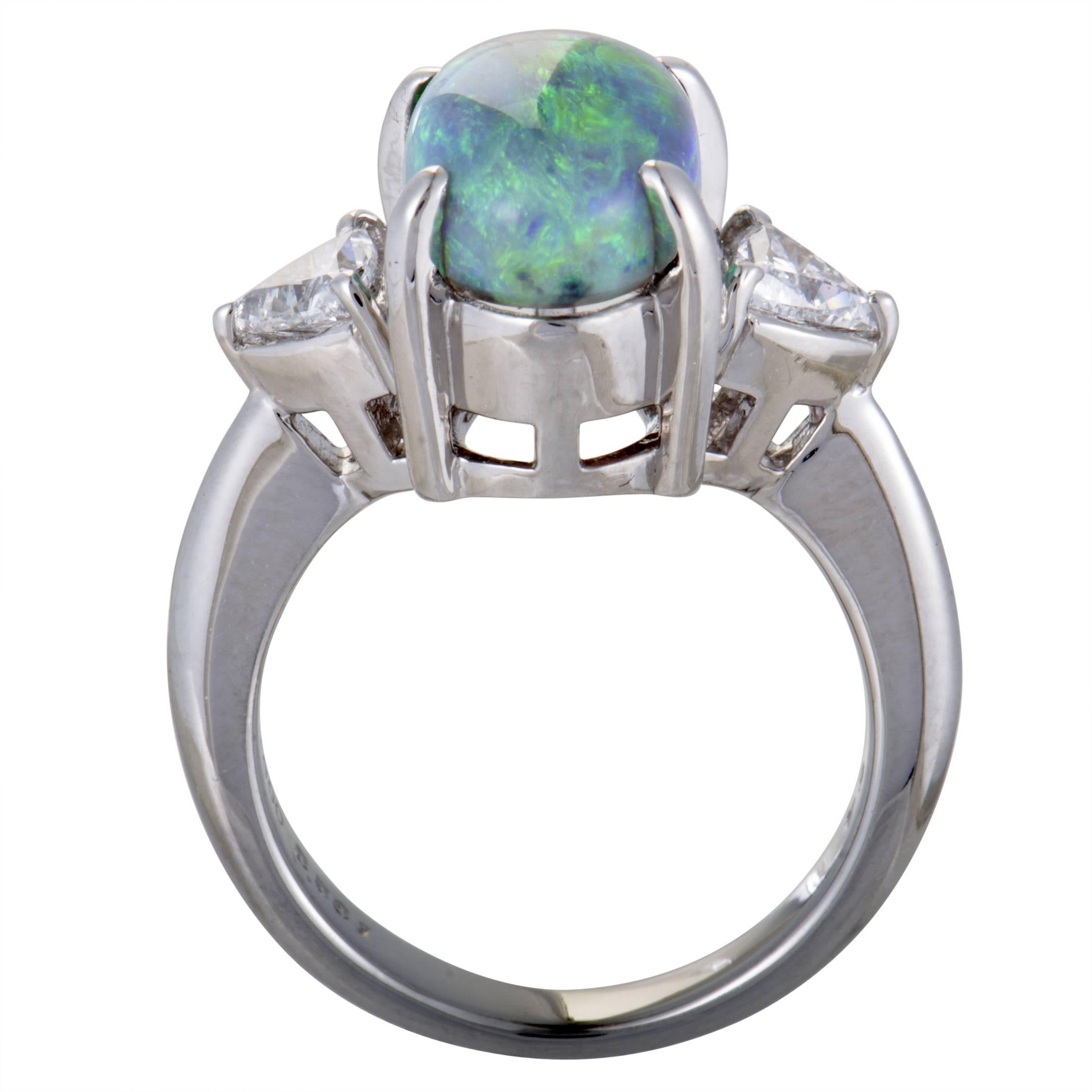 The alluring opal is harmoniously complemented by the elegant platinum in this stunning ring that boasts incredibly fashionable appeal. The opal weighs 3.58 carats and it is accompanied by glistening diamond stones that weigh 0.54 carats in