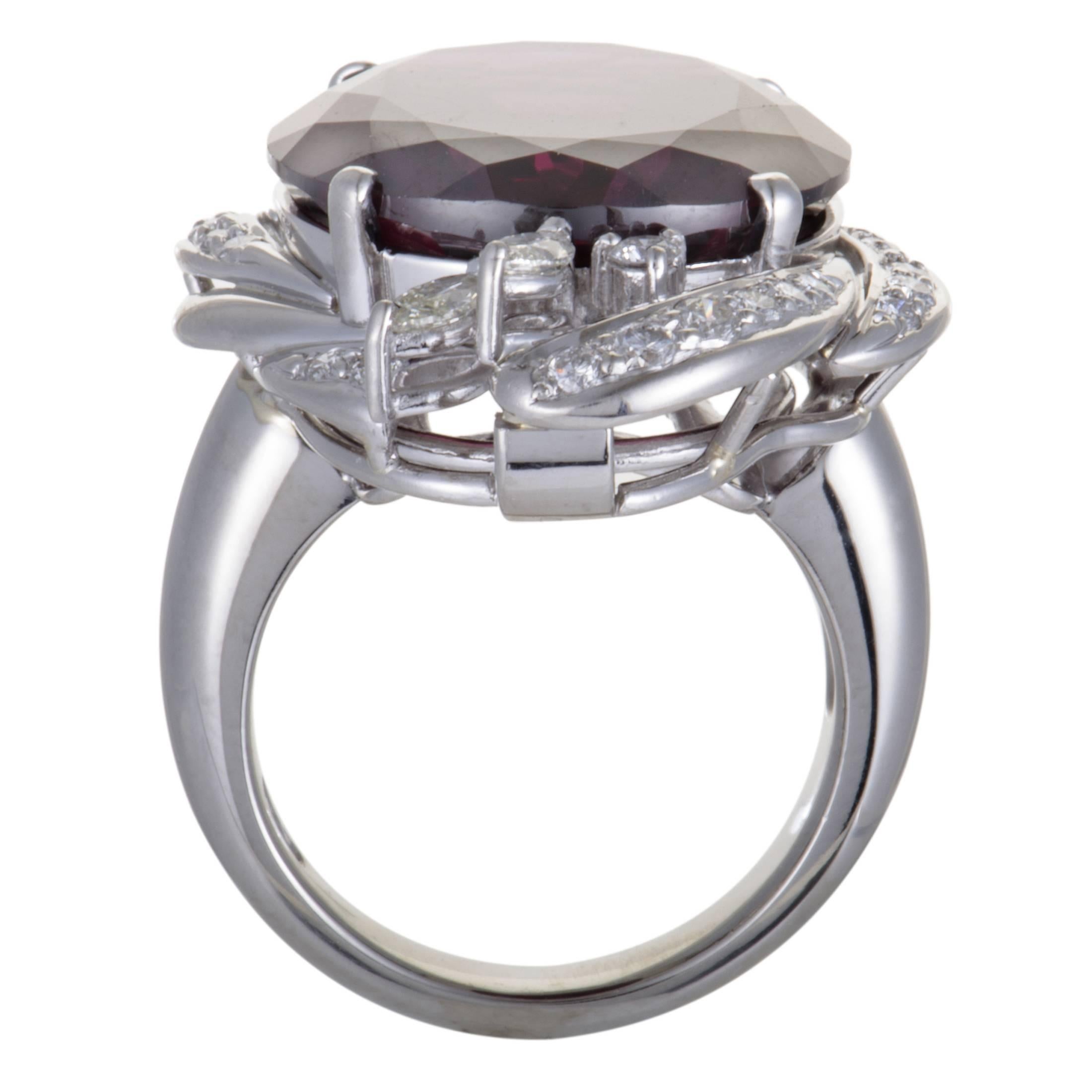 This fascinating ring is an item of prestigious quality and refined aesthetic style. The fabulous shimmer of platinum in its design is perfectly complemented with the timeless resplendence of  diamonds, weighing 1.10ct, and a spectacular purple