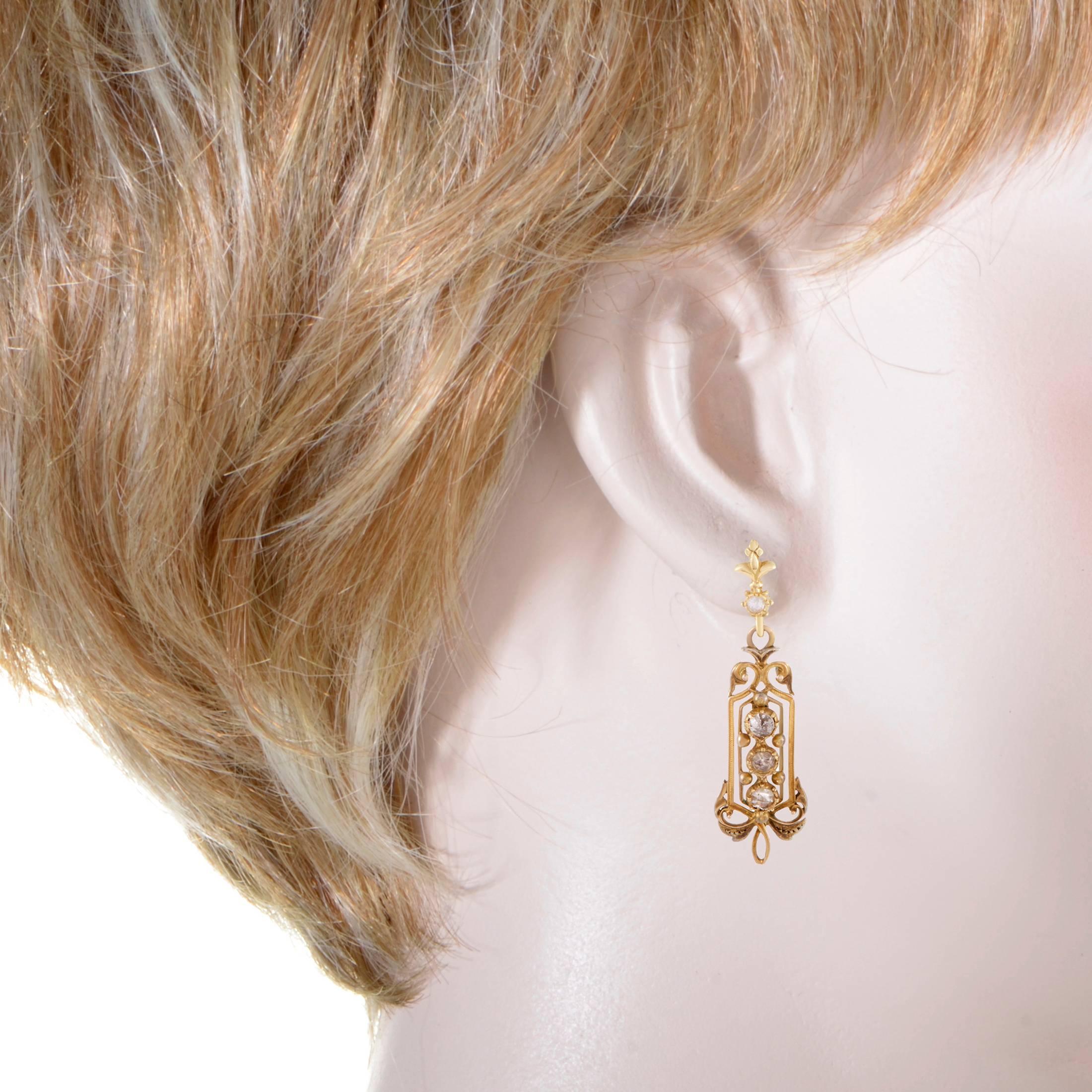 With a design reminiscent of the iconic Victorian era pieces, these extravagant earrings exude classy elegant appeal with a certain antique feel to them. The pair is made of sophisticated 18K yellow gold and decorated with splendid rose cut diamond