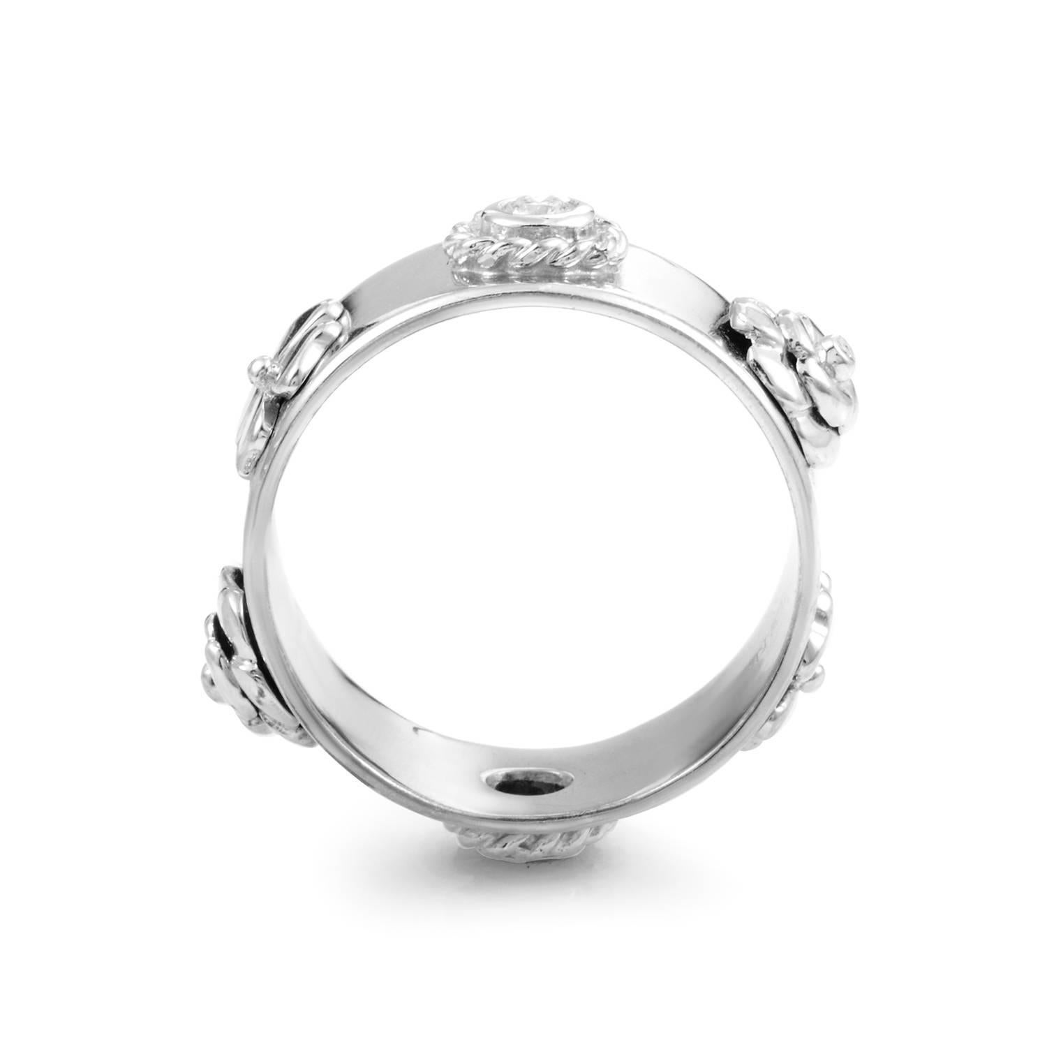 A floral theme is applied with meticulous mastery to this ring design from Chanel. 18K white gold is given perfect spin through the band, and across its surface in precise measures flora motifs rise to prominence with fluidity. Two of which boast a