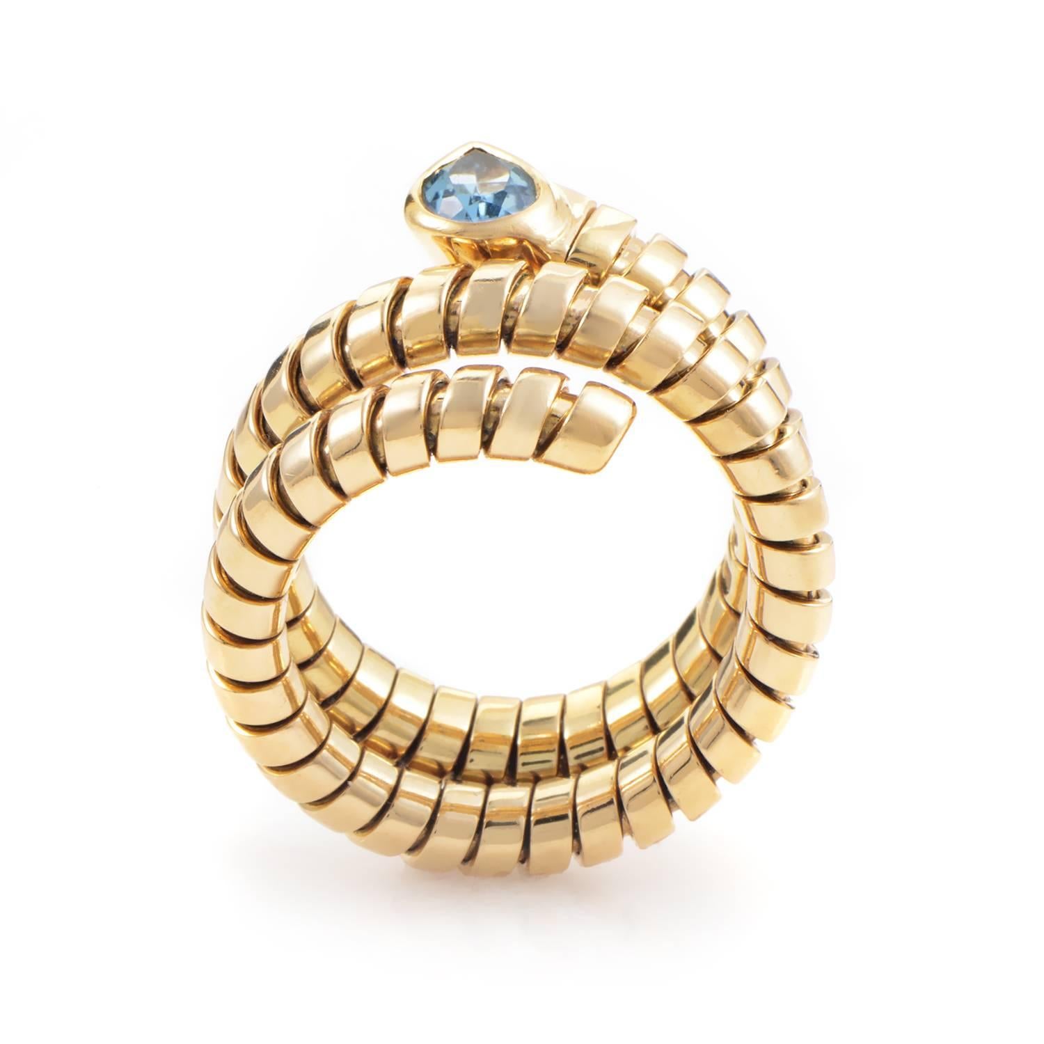 With serpentine sleekness this Tubogas ring wraps snugly three times in a glamorous grasp of 18K yellow gold. Leading this rivulet of precious slivers is the ripe setting of topaz that punctuates the ring's rippling curves. Compelling style and