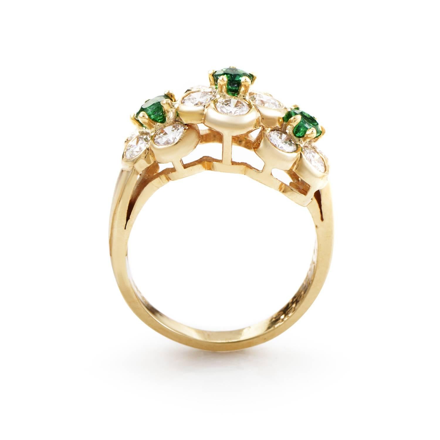 The band of 18K yellow gold spins upward to gather a bouquet of precious stones spilling from the top. A mix of 0.40ctct of emeralds and 1.00ct of diamonds twinkle in their luxurious arrangement. An lavish spill of class and style that fits on the