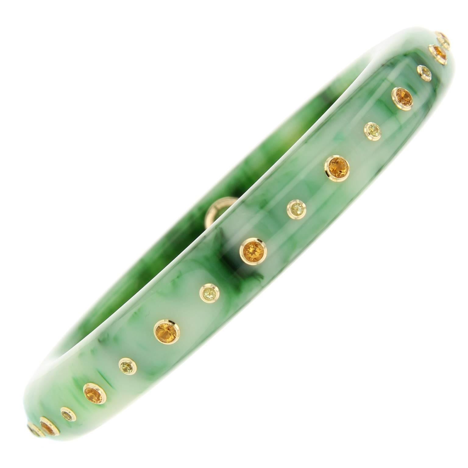 This marbled green bakelite bangle is perfectly studded with citrine and peridot   bezel-set in 18k yellow gold.

Full details below:
• From the Mark Davis Bakelite collection
• Marbled green bakelite 
• 1.60 ct citrine, 0.64 ct peridot
• Polished