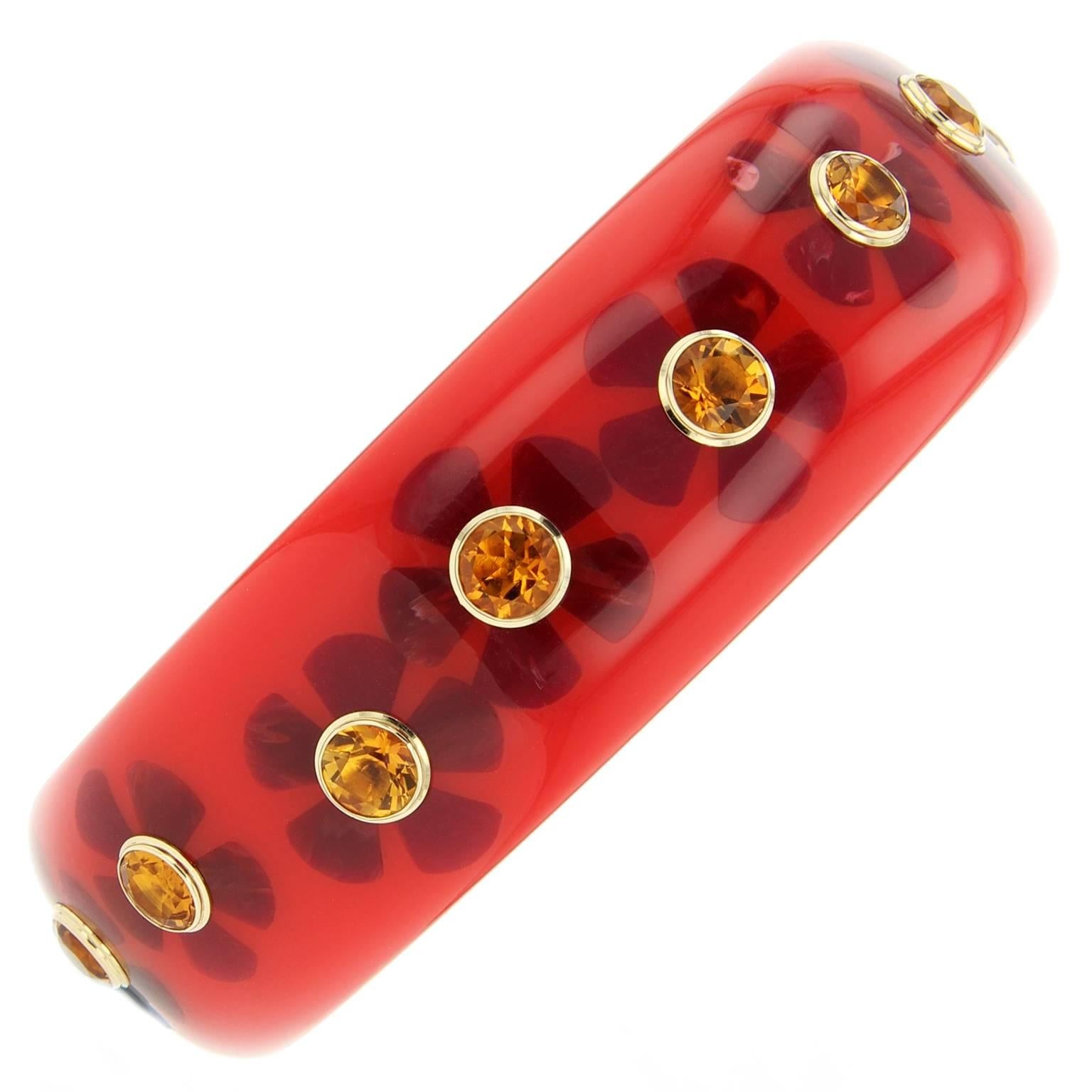 This cheerful Mark Davis bangle is handcrafted of red vintage bakelite and finely inlaid with burgundy bakelite flowers.  At the center of each flower is a large citrine bezel set in 18k yellow gold. 

Full details below: 
• Part of the Mark Davis