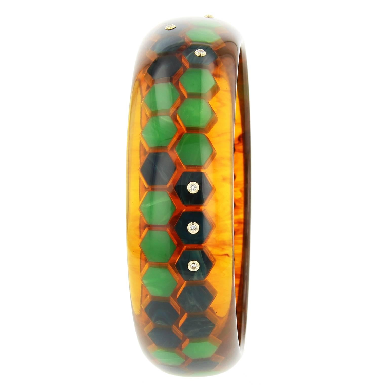 This chic Mark Davis bangle was handcrafted using tortoise vintage bakelite.  It was skillfully inlaid with hexagonal pieces of green and blue bakelite creating a honeycomb pattern.  Fine diamonds set in 18k yellow gold bezels are randomly applied