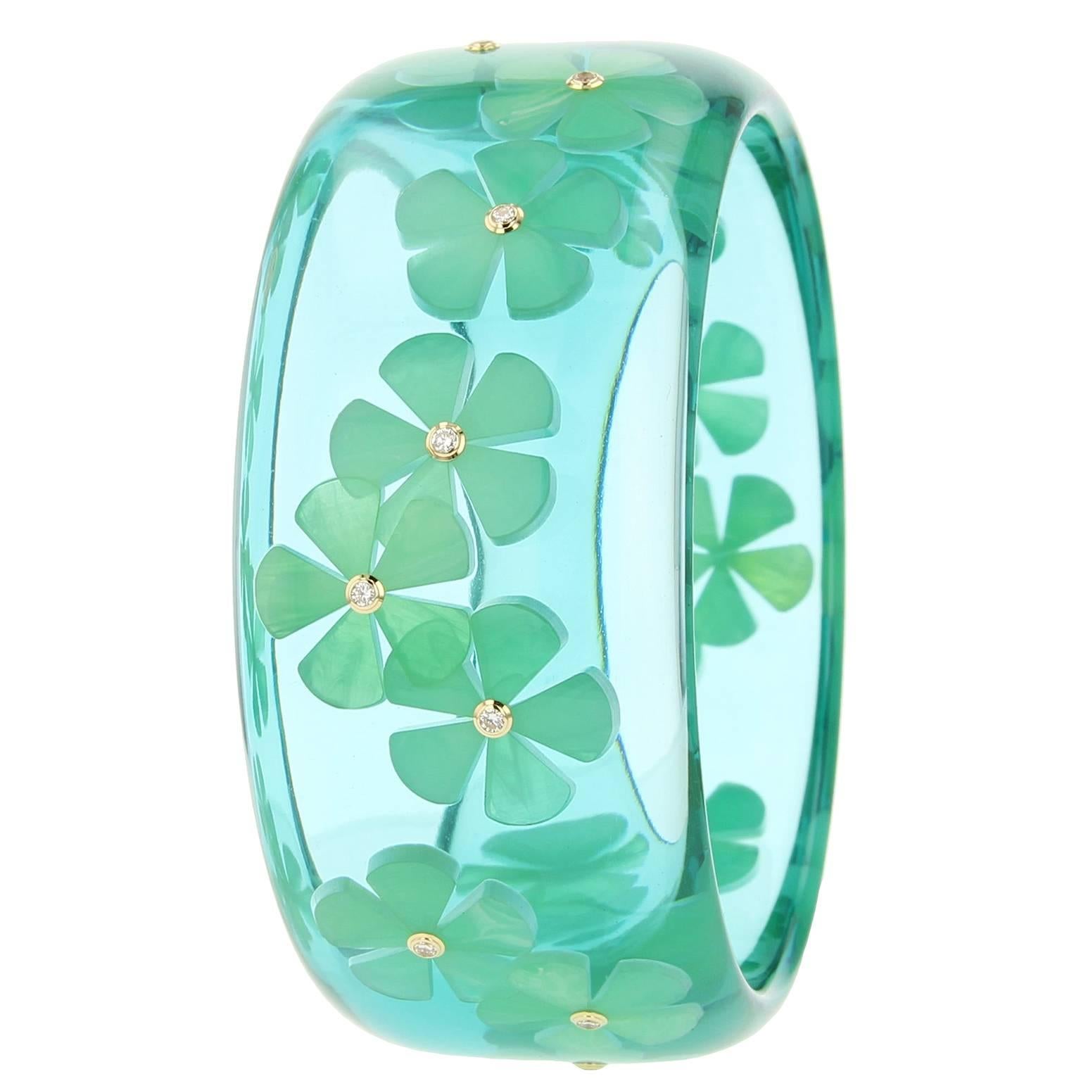 This unique Mark Davis bangle was handcrafted using bluish green vintage prystal bakelite. At the center of each inlaid flower is a fine diamond set in an 18k yellow gold bezel. 

Full details below: 
• Part of the Mark Davis Collector line
•