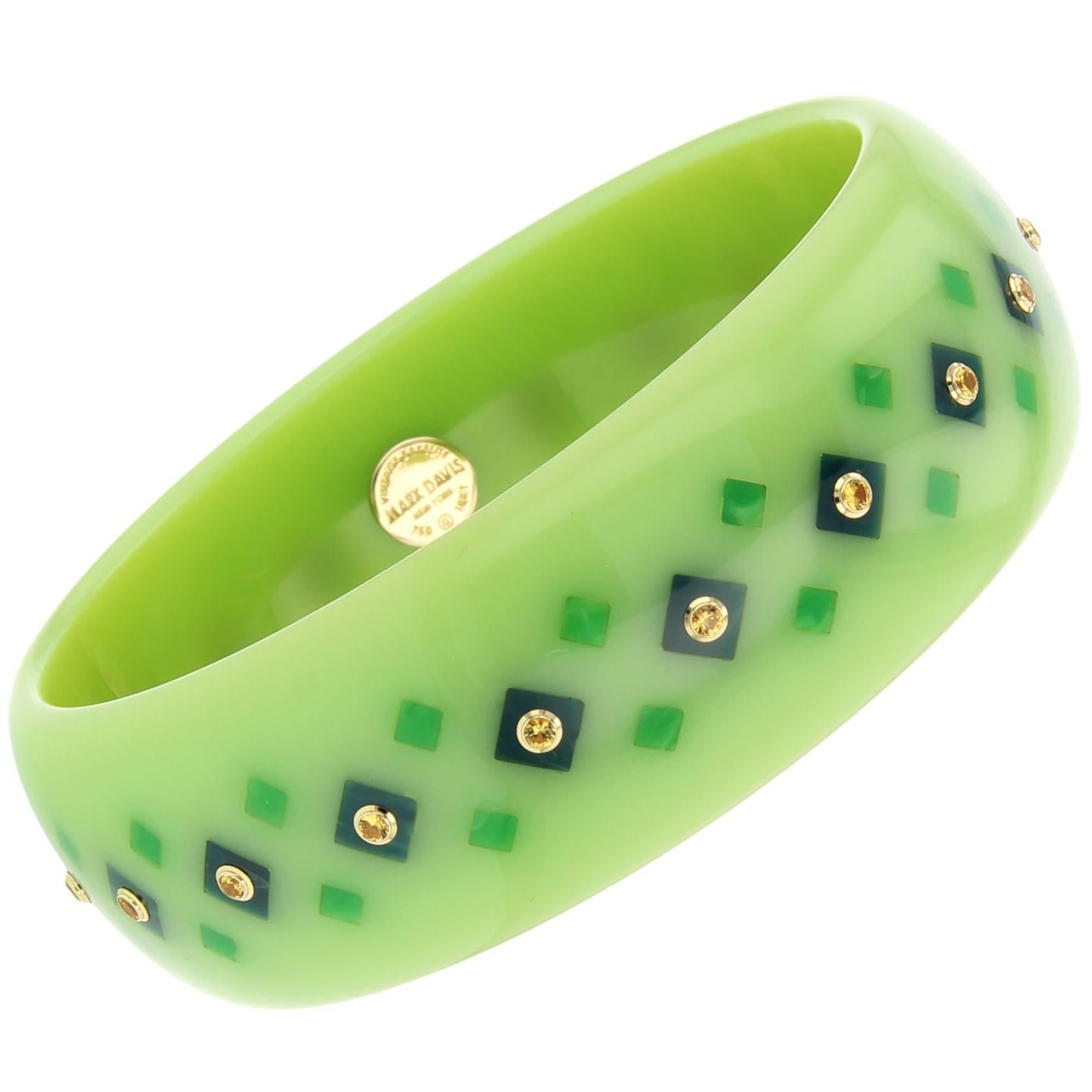 This eye-catching soft green vintage bakelite bangle is part of the Mark Davis Collector line. Masterfully inlaid with square shaped pieces of blue and green bakelite and studded with fine yellow sapphires bezel-set in 18k yellow gold.

Full details