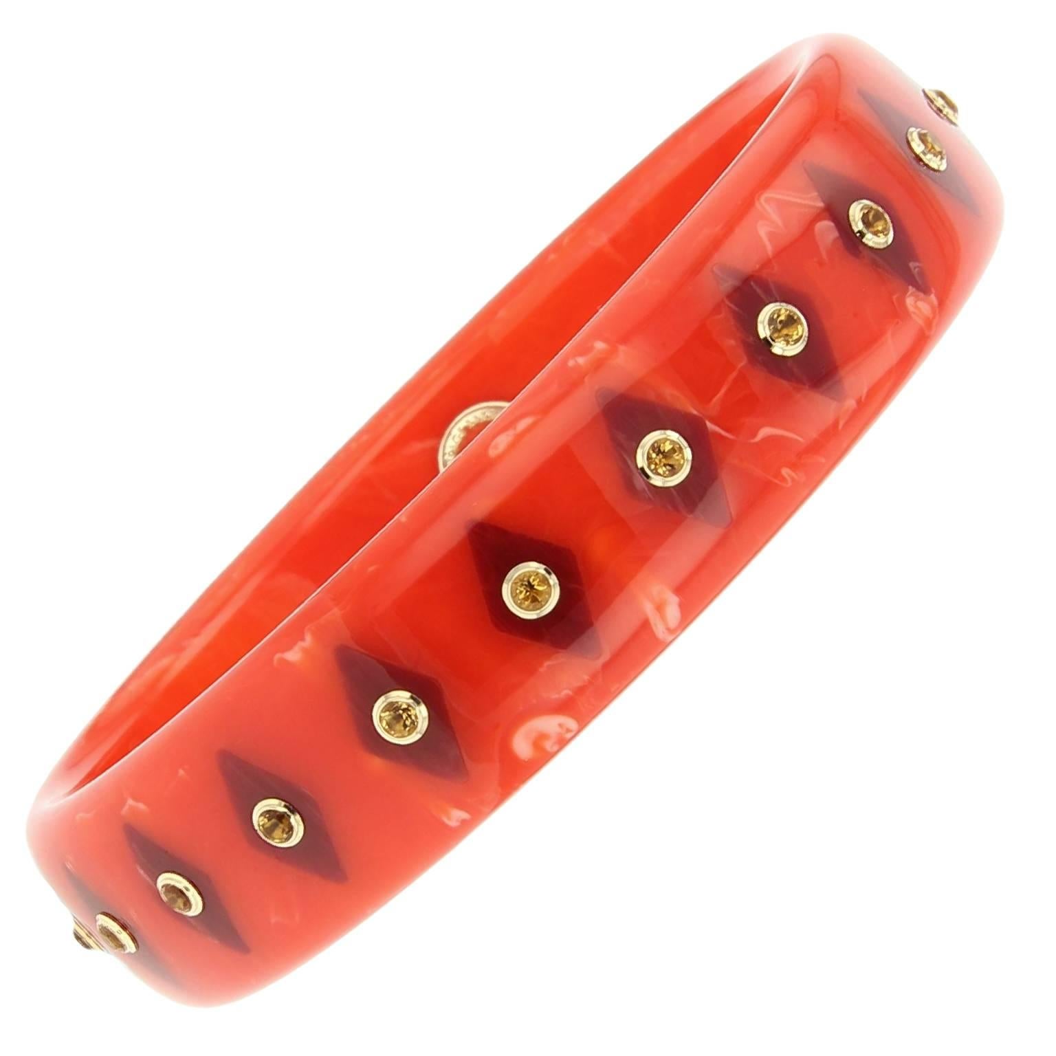 This vibrant Mark Davis bangle was handcrafted of orange marbled vintage bakelite. Inlaid with burgundy marquise-shaped pieces of bakelite and studded with fine citrine bezel-set in 18k yellow gold. 

Full details below: 
• From the Mark Davis