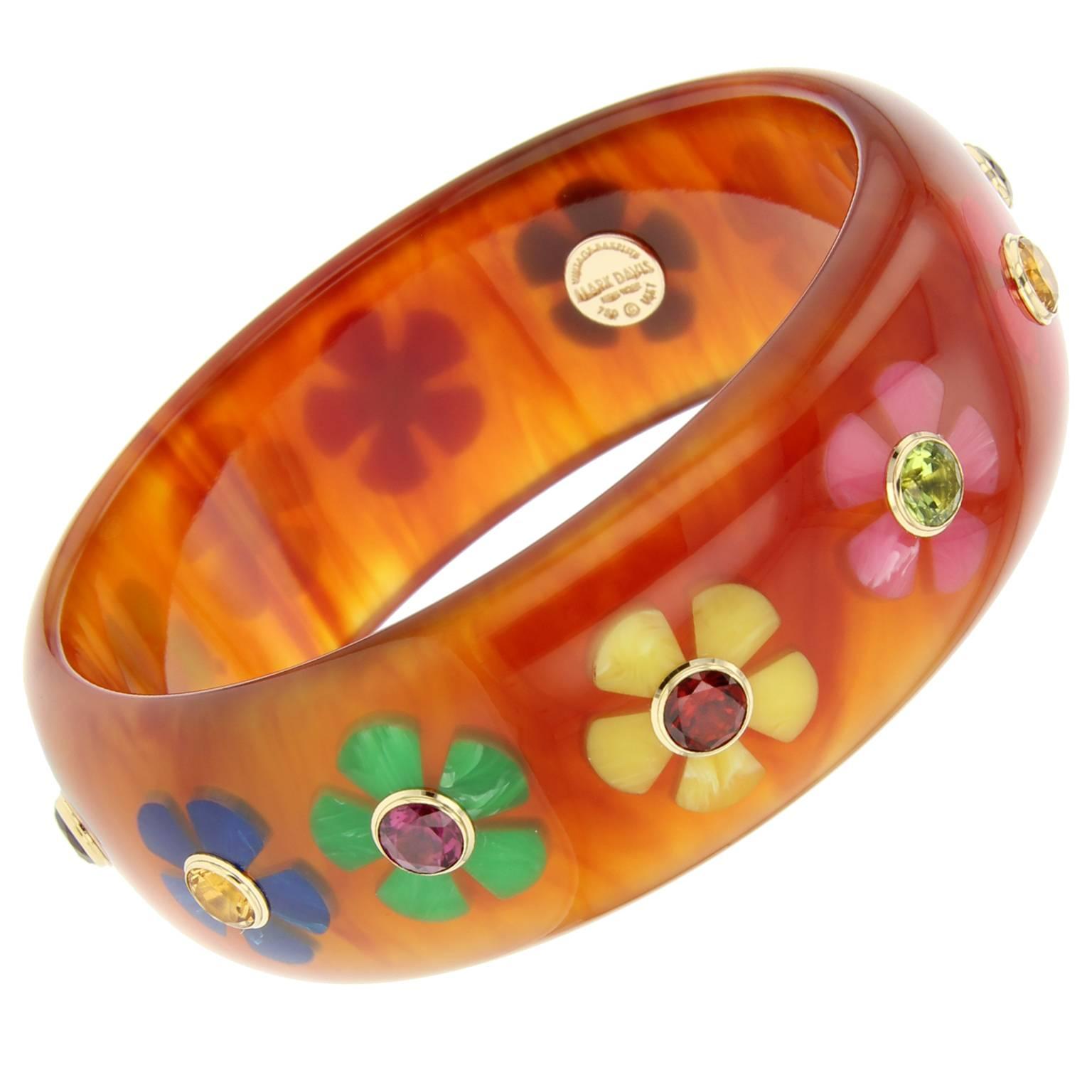 This Mark Davis bangle was handcrafted of tortoise vintage bakelite and finely inlaid with multi colored bakelite flowers.  At the center of each flower is a large citrine, garnet, or peridot bezel-set in 18k yellow gold. 

Full details below: 
•