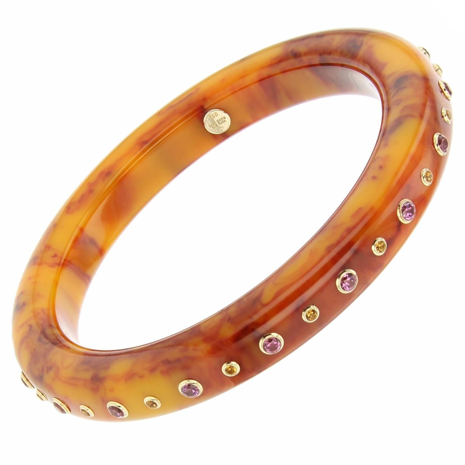 This slim Mark Davis bangle was handcrafted using marbled orange vintage bakelite.  A line of alternating citrine and rhodolite garnet bezel-set in 18k yellow gold encircles the bangle. Beautiful on its own, this bangle makes a stunning addition to