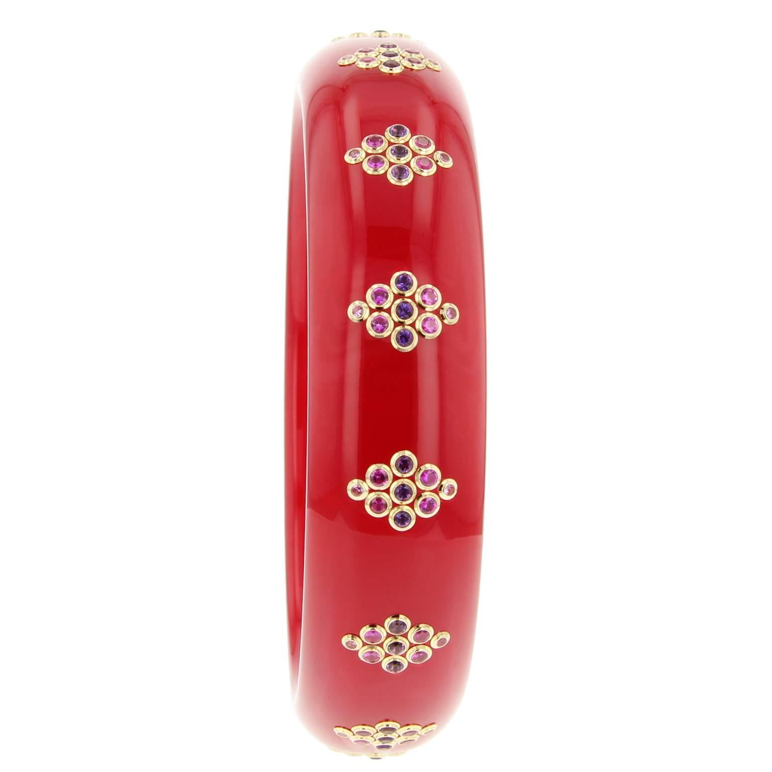 This beautiful red Mark Davis bangle was handcrafted of vintage solid red bakelite.  The applied diamond-shaped motifs are created using amethyst and very fine pink sapphires set in 18k yellow gold bezels.  

Full details below: 
• From the Mark