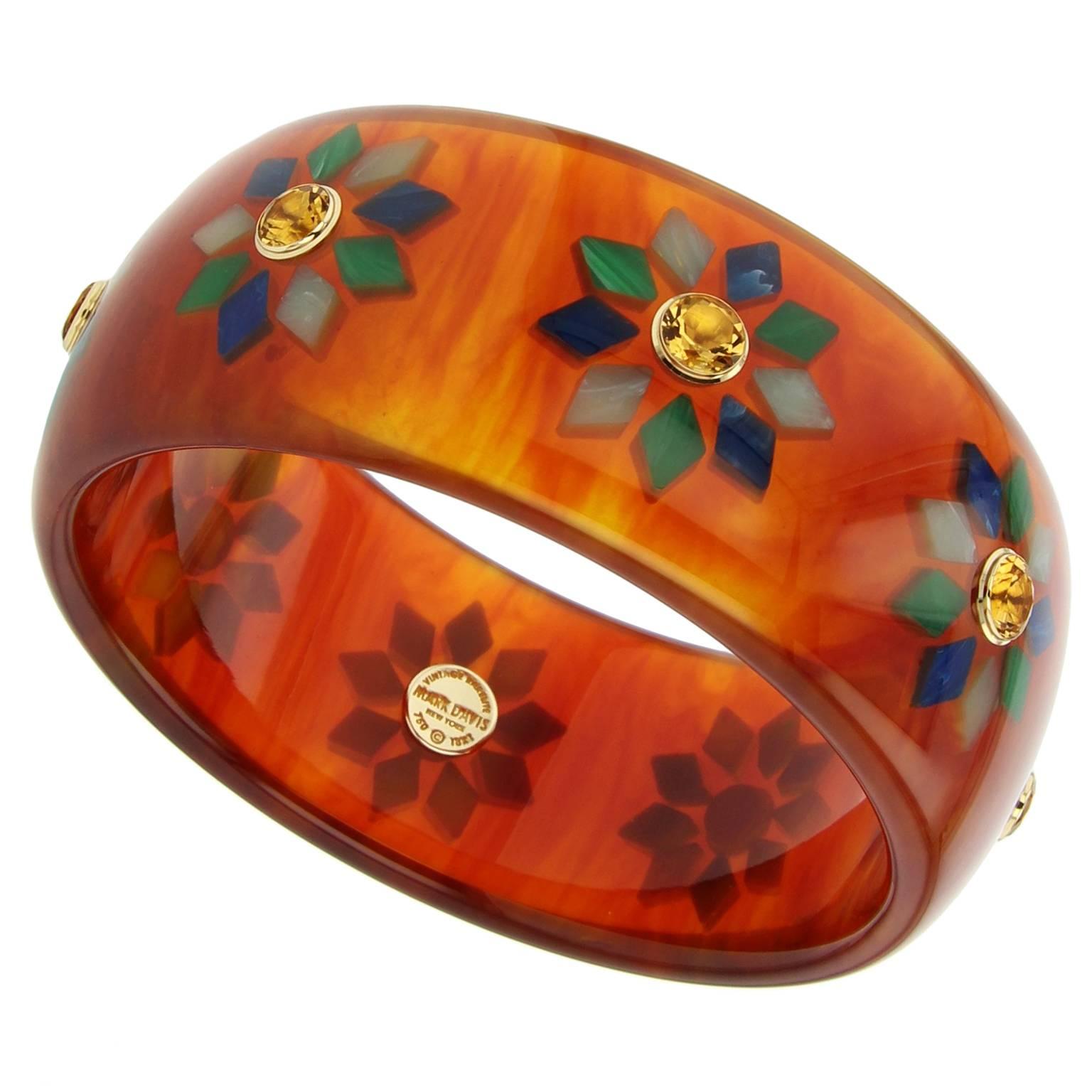This unique and bold Mark Davis Collector bangle was handcrafted using vintage tortoise bakelite.  The geometric motif was precisely inlaid with diamond-shaped pieces of green and blue bakelite.  Each station is centered with a citrine, bezel-set in