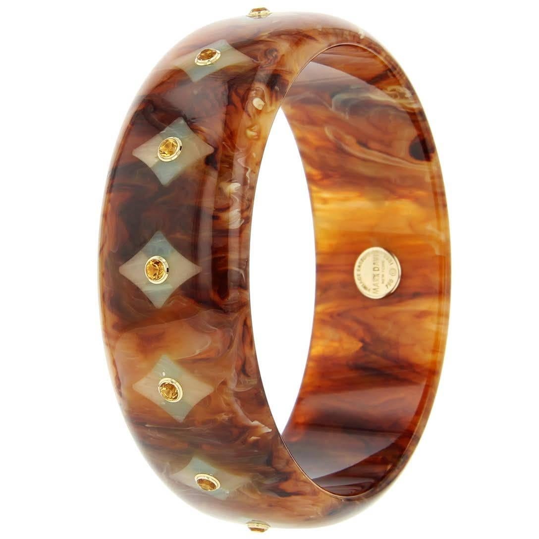 This beautiful Mark Davis bangle was handcrafted using vintage marbled brown bakelite. The diamond-shaped mosaic pattern was precisely inlaid with pieces of blue and beige bakelite.  Each diamond-shape is centered with a citrine, bezel-set in 18k