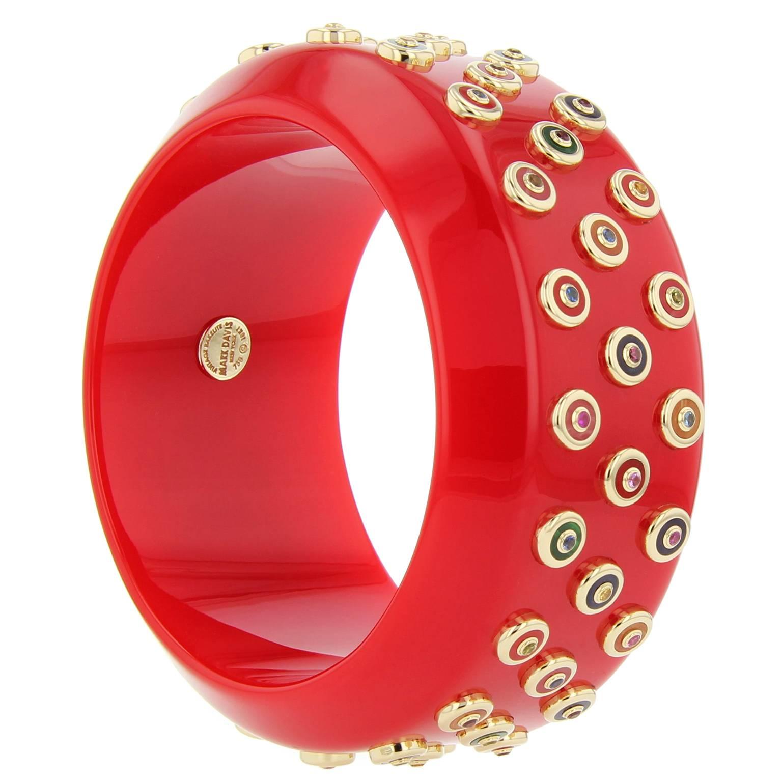 This bold and unique Mark Davis bangle was handcrafted using solid red vintage bakelite. Each 18k yellow gold stud is inlaid with various multi-colored bakelite pieces and topped with amethyst, citrine, garnet, peridot, smoky quartz or pink, yellow