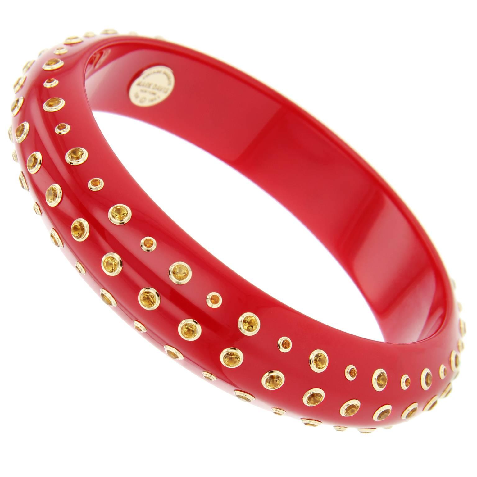 This vibrant Mark Davis bangle was handcrafted using solid red vintage bakelite. Shaped into a knife edge profile, it is precisely studded on all three sides with citrine set in 18k yellow gold bezels. 

Full details below: 
• From the Mark Davis