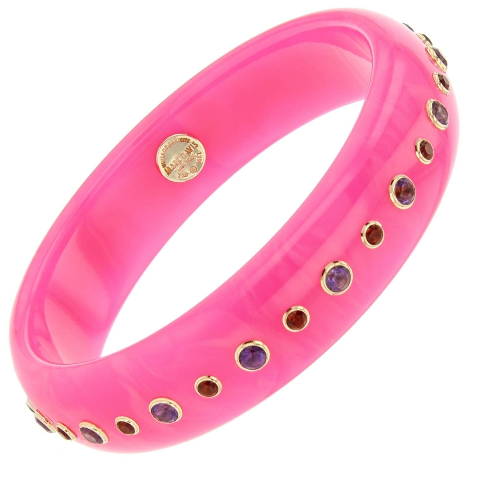 This delightful bangle is part of the Mark Davis Bakelite Collection. It was handcrafted using vivid pink bakelite and studded with amethyst and citrine, bezel-set in 18k yellow gold.    

Full details below: 
• From the Mark Davis Bakelite