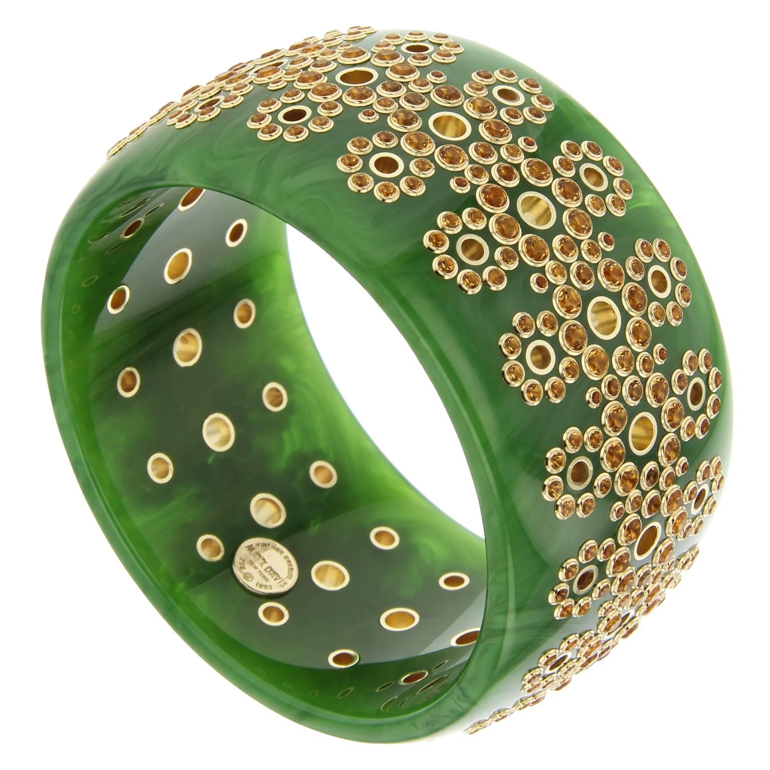 This spectacular Mark Davis bangle was handcrafted from richly marbled green vintage bakelite. The bangle is pierced with 18k gold lined holes and studded with citrine bezel-set in 18k yellow gold. Requiring a tremendous amount of time and labor,