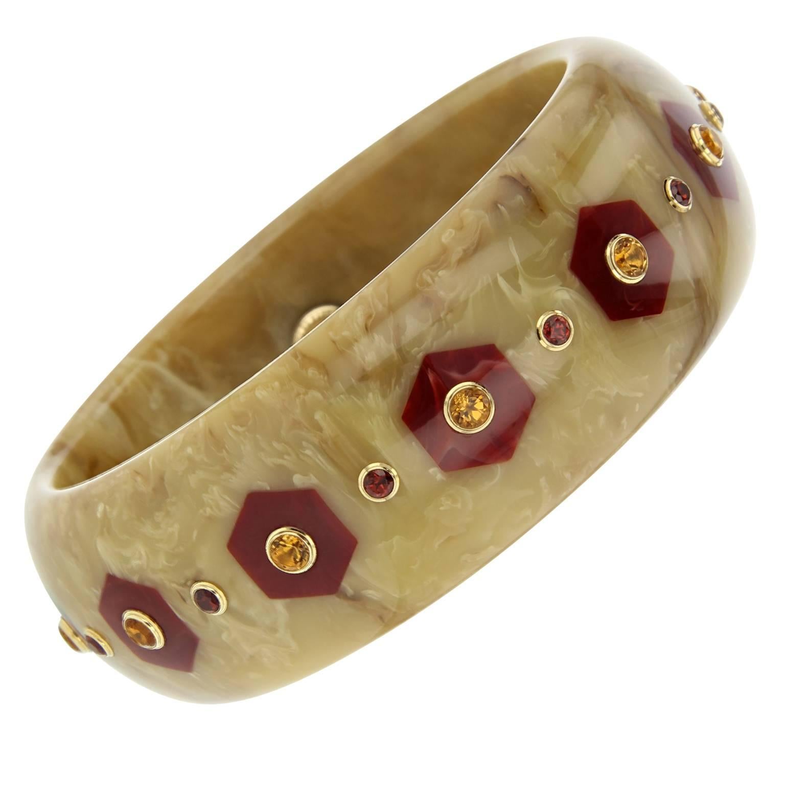 This Mark Davis bangle was handcrafted using marbled beige vintage bakelite and meticulously inlayed with hexagonal shaped pieces of burgundy bakelite. Each hexagon is centered with a citrine and in between is a rich mozambique garnet, bezel-set in