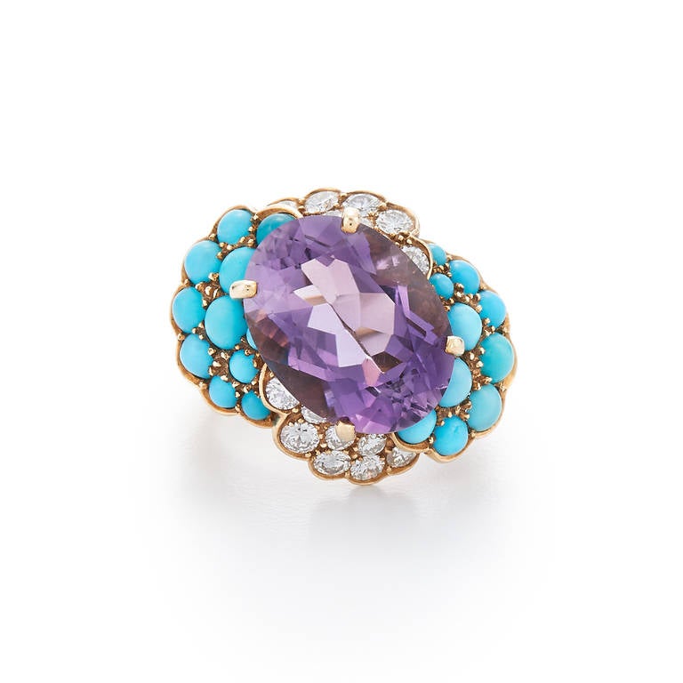 1960s Amethyst Turquoise Diamond Yellow Gold Cocktail Ring

An oval amethyst weighing approximately 7.50 carats is accented with turquoise cabochons and round diamonds totaling approximately 0.90 carat in an 18 karat yellow gold and platinum