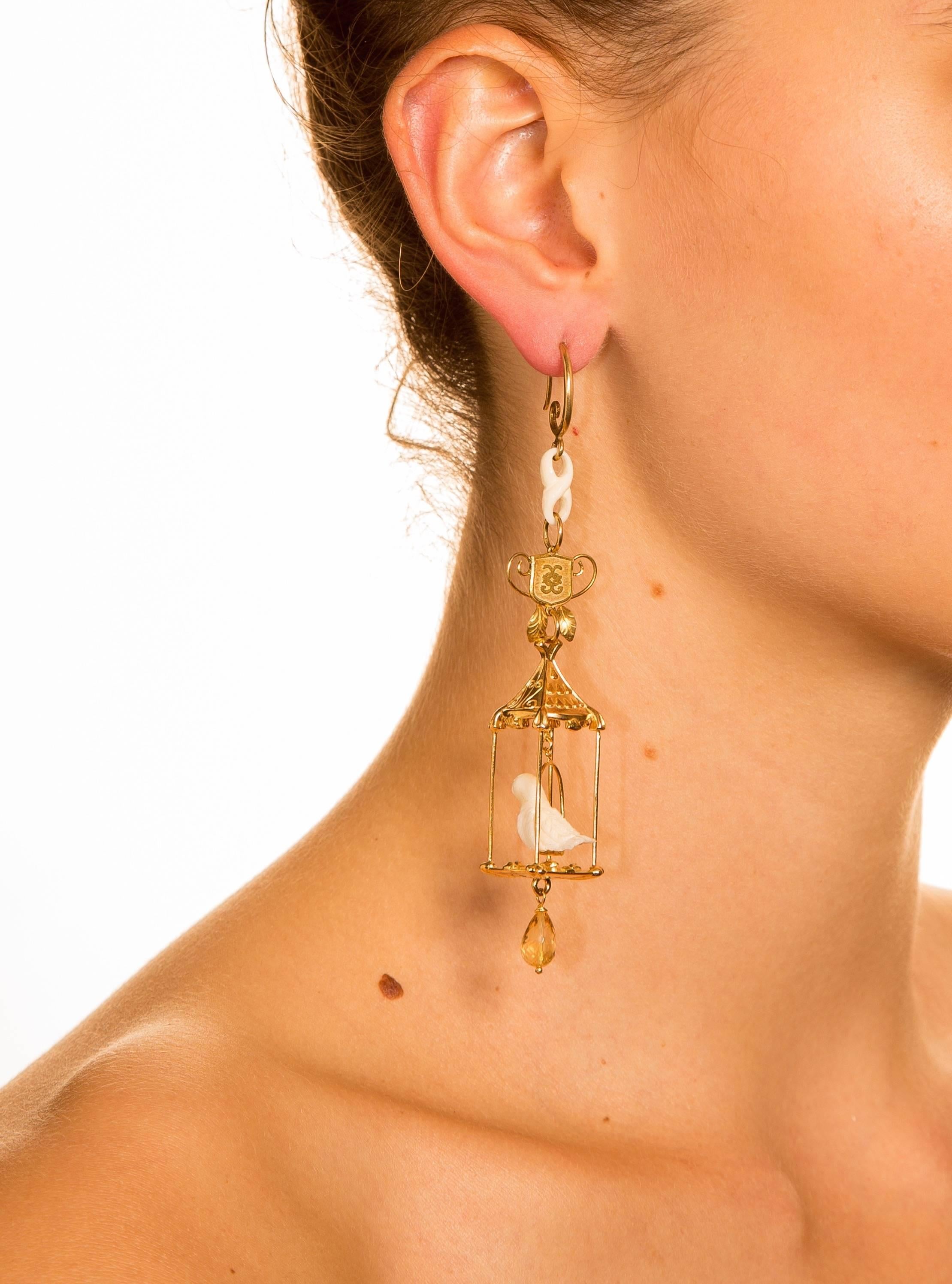 Lovingly crafted by master Italian artists and goldsmiths, these gilded bird cage earrings are exquisite works of wearable art.

The songbirds are delicately hand sculpted. The CdG shield is evocative of Medieval heraldry. 

Special Requests: For