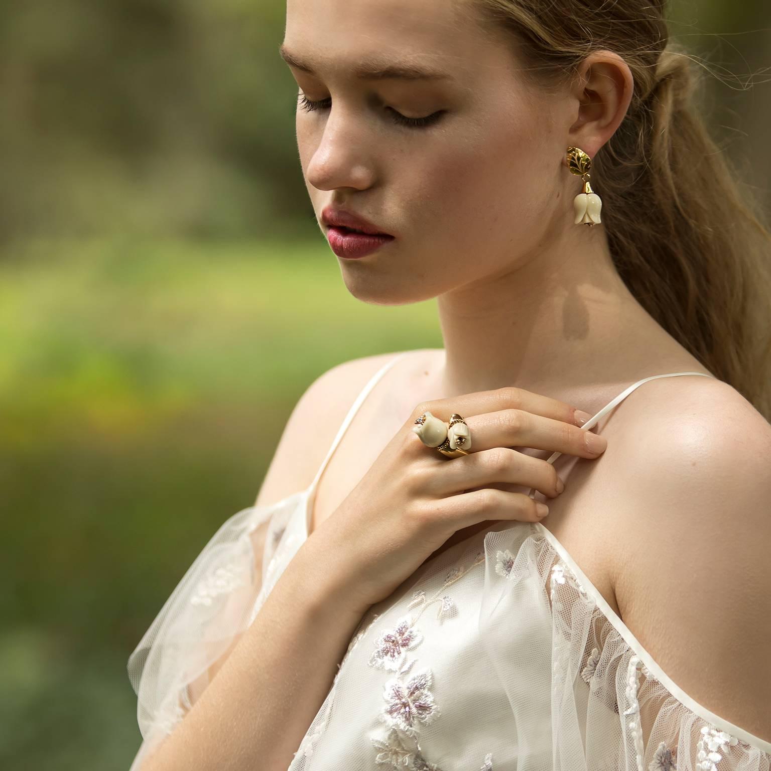 Handmade and carved in Italy. These graceful and feminine earrings reflect the fleeting beauty of the pure white tulips. Gold and diamonds and Nuvory® combine to capture Nature’s brief but impressive explosion of beauty.  A gorgeous white flower –