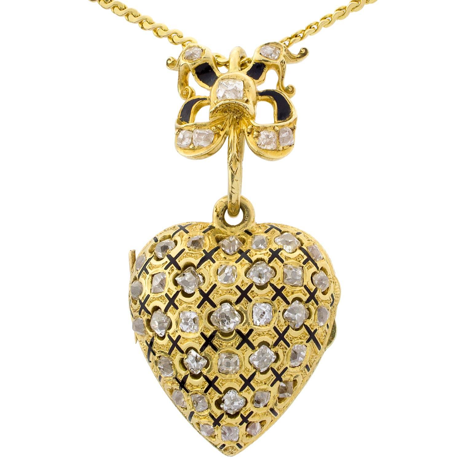 Late 19th century heart-shaped gold locket with gold chain, set with single cut diamonds, with a total weight of 1.90 carats, decorated with enamel. Initials can be seen on the back.