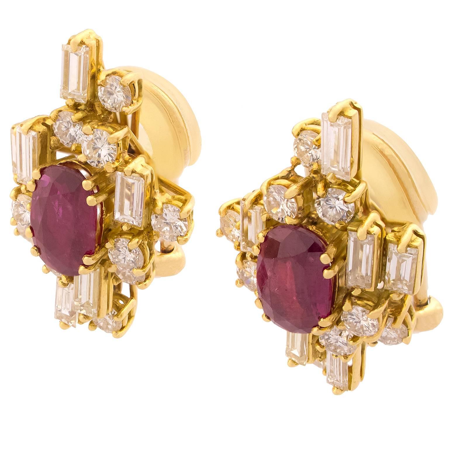 Yellow gold earrings centered by two oval cut rubies with a total weight of 1.15 carats, surrounded by 32 baguette and round brilliant cut diamonds, totalling 1.80 carats.