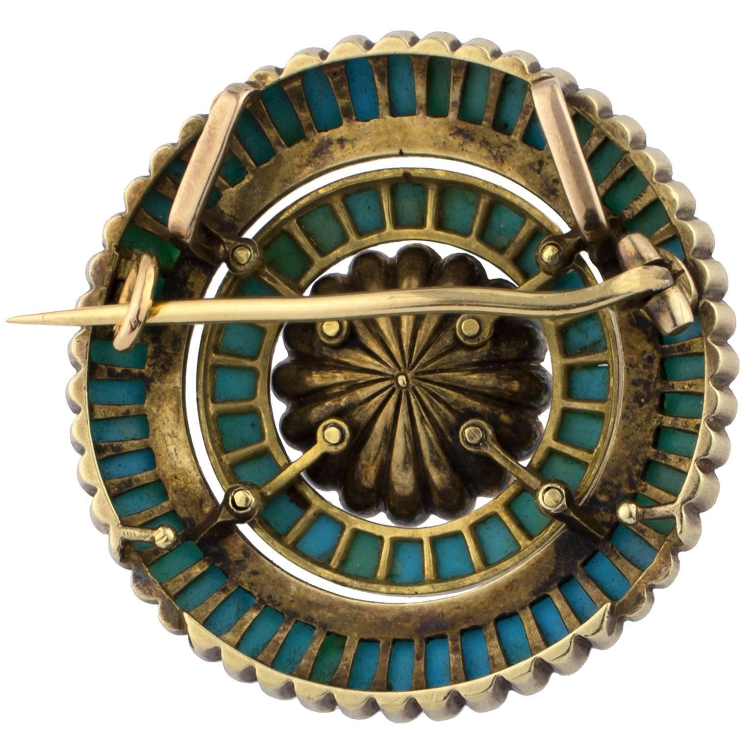 19th century Victorian brooch decorated with a central pearl surrounded by layers of diamonds and turquoises in a rosette setting.