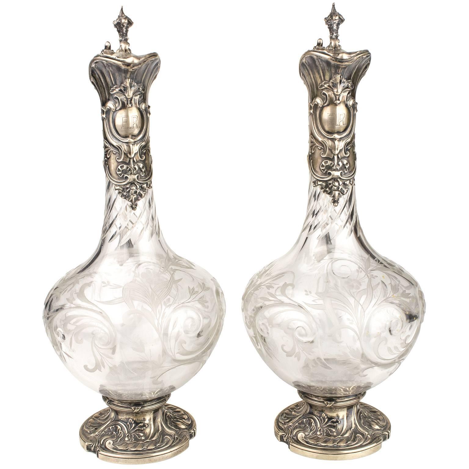 Pair of German silver and glass jugs from the early 20th century retailed by L. Posen Witwe. It shows the manufacturer’s mark of P. Bruckmann & Söhne of Heilbronn
