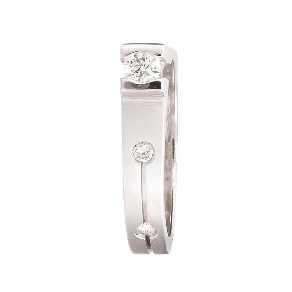 Gold ring where beauty is not necessarily at the center. White gold, weight 7.60gr/0.017lb, brilliant cut diamond 0.15ct + 0.09ct. Shaped by hand, made using the lost-wax process. Can be made for all finger sizes. Possible engraving at no extra cost.