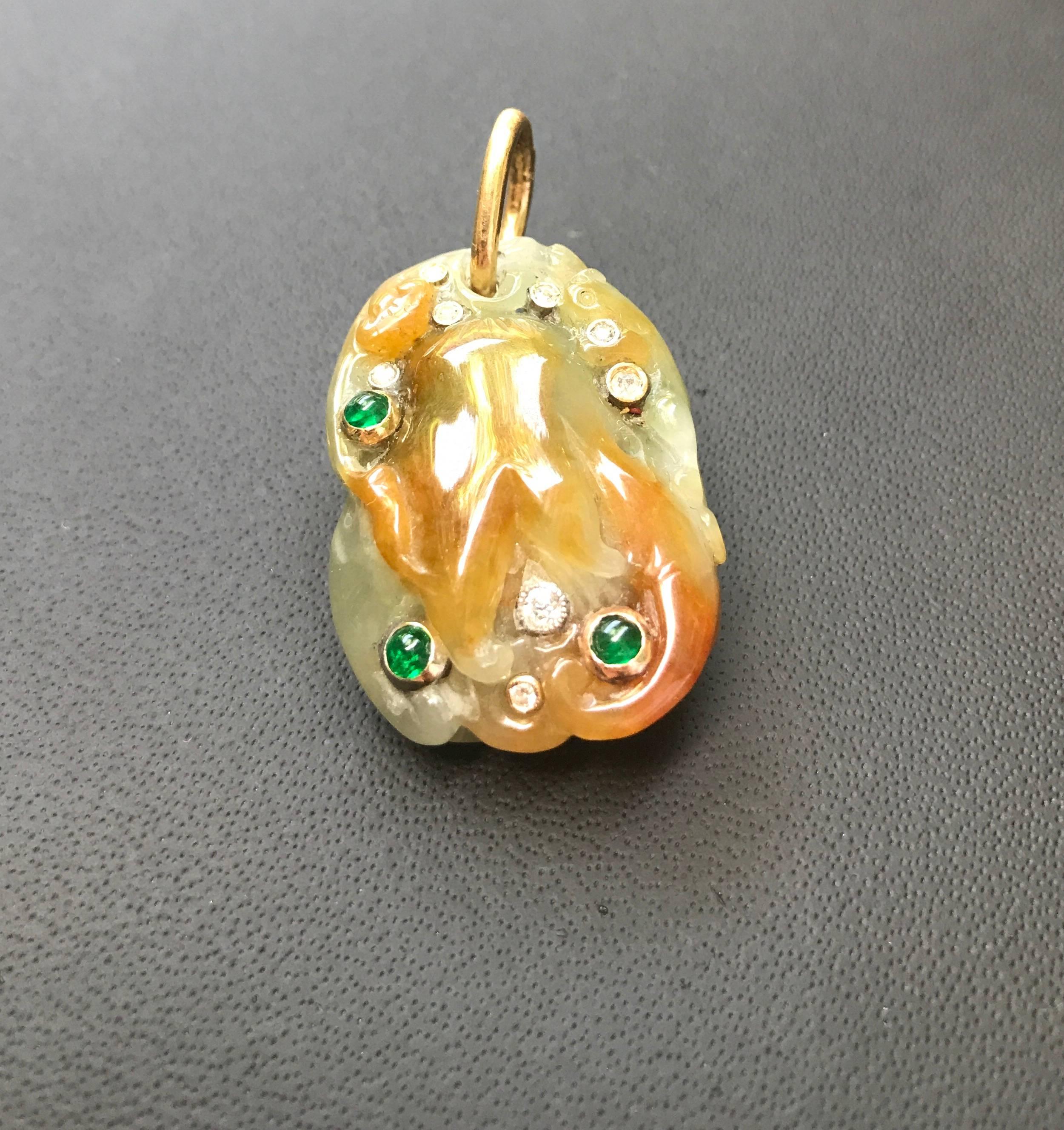 Beautiful hand-carved pendant made in natural jade embellished with cabochon of emeralds and diamonds.